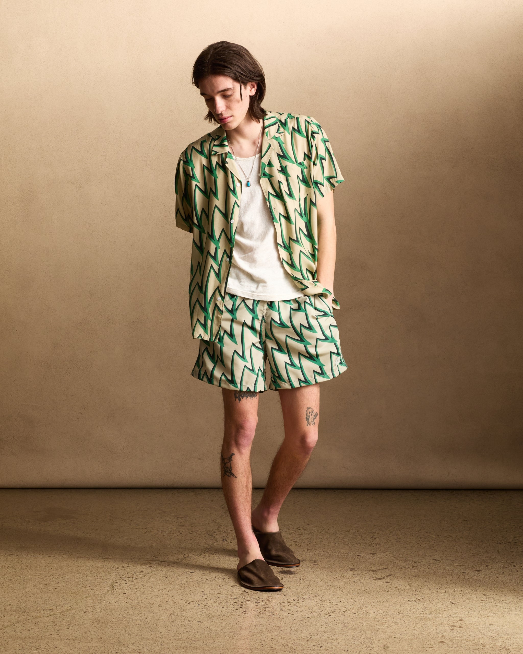 model wearing Light brown, green, and black Jagged Frenzy Rayon Camp Shirt