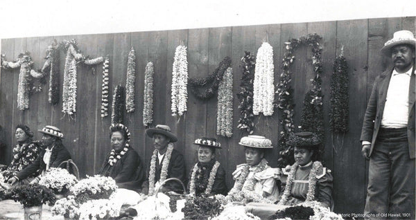 Lei vendors seated on the pier selling leis.