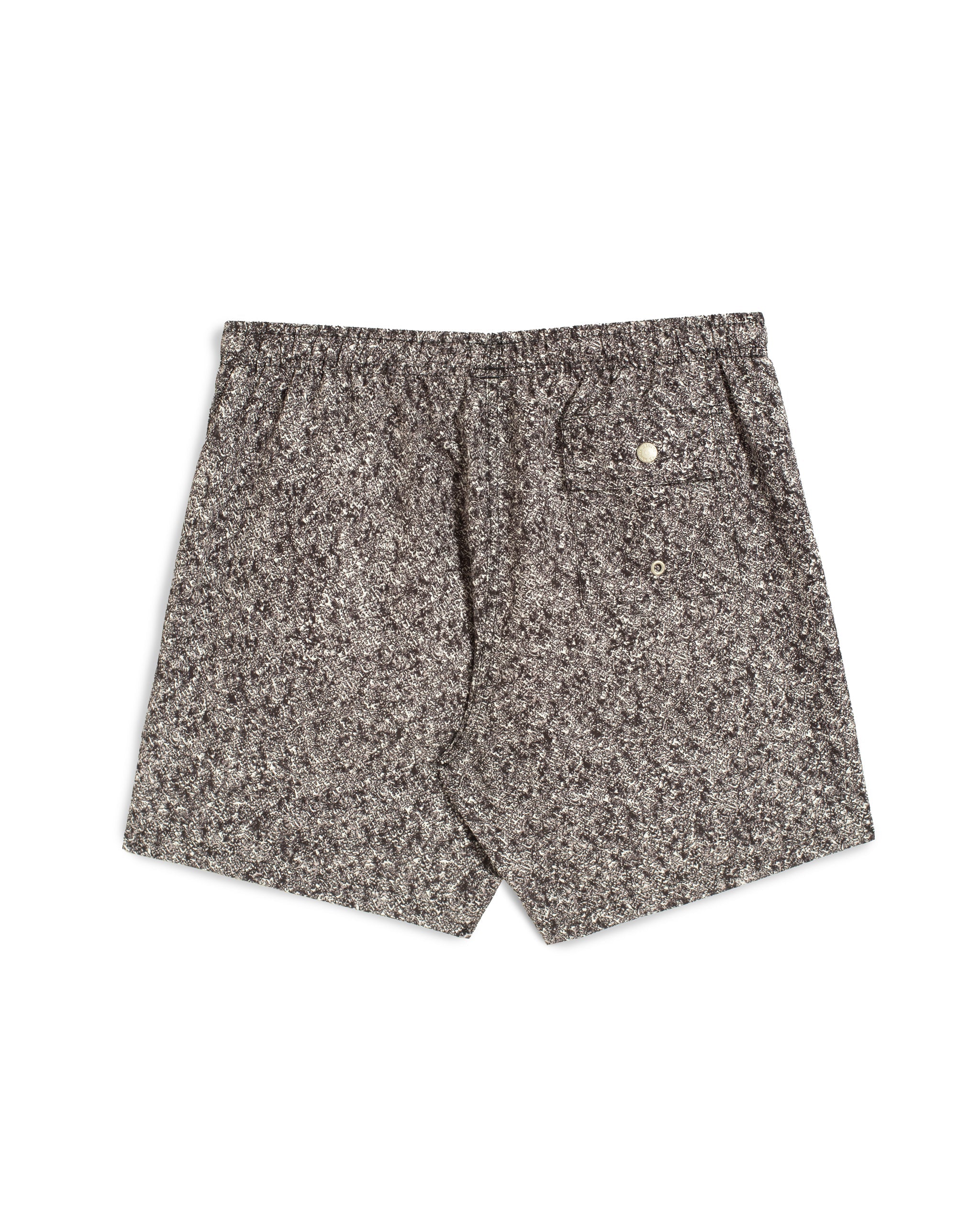Rear view of men’s black swim trunks with grey floral scroll stripe pattern and a back button-closure pocket