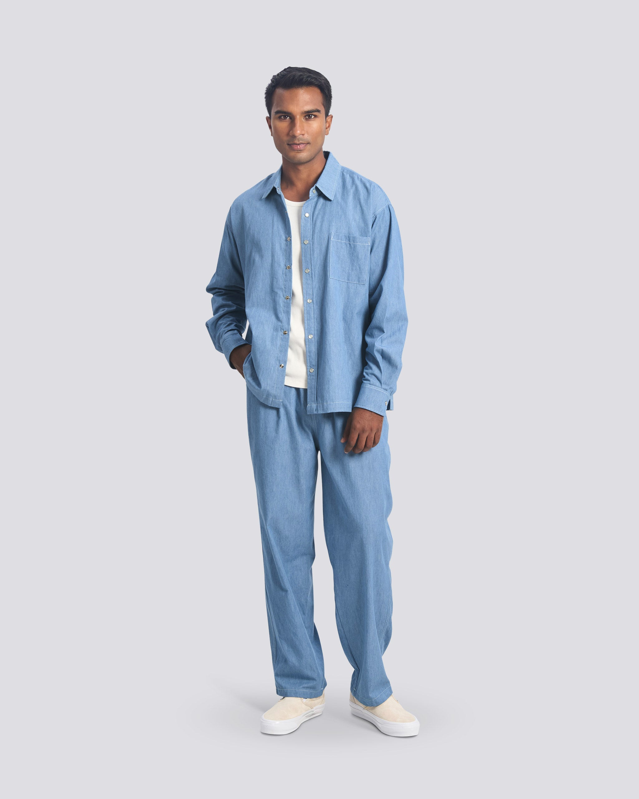 Bather Men's Faded Denim Leisure Shirt and matching Leisure Pants set in light blue, worn by a model against a grey studio background.