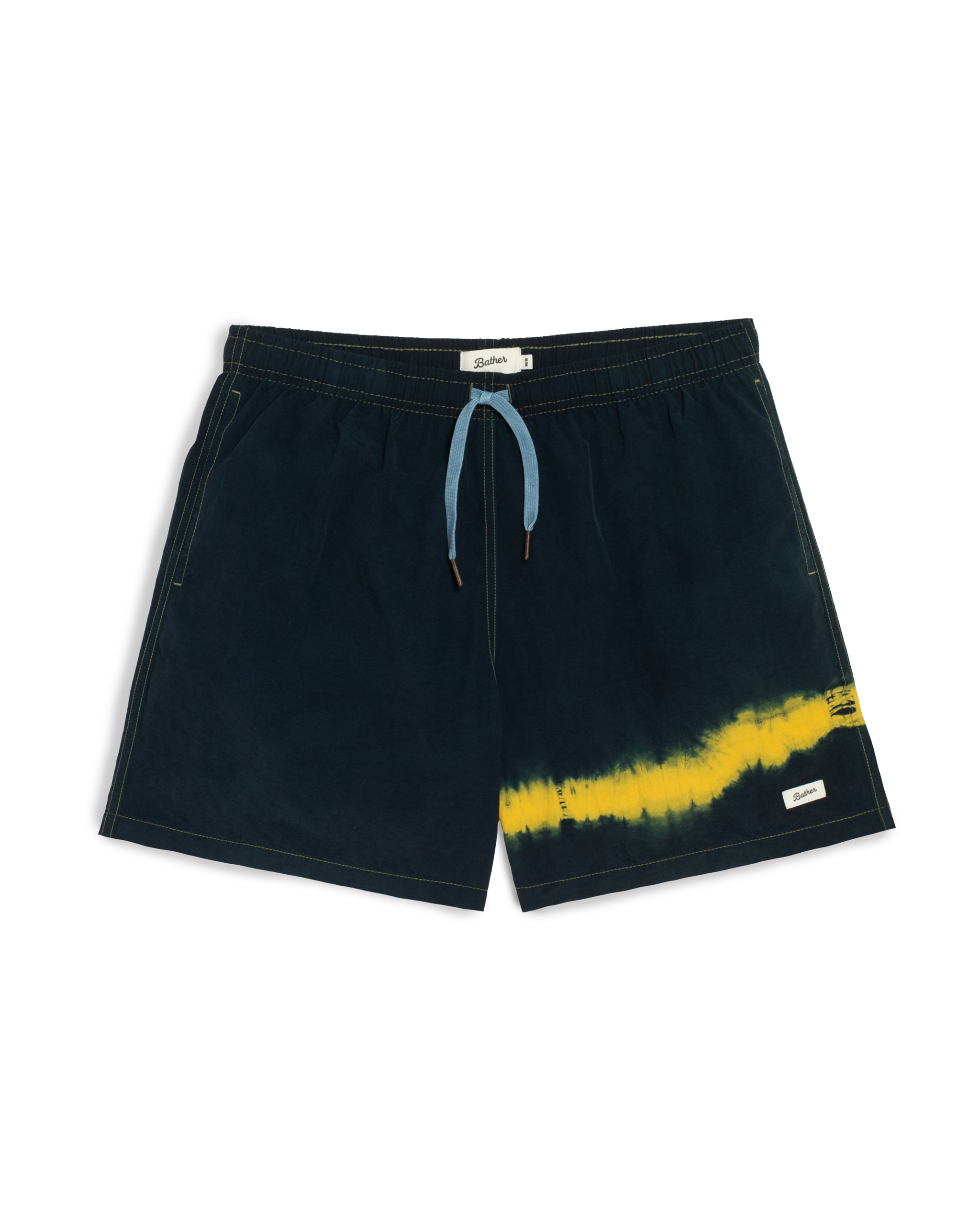 Navy indigo shorts with yellow tie-dye design on a white background