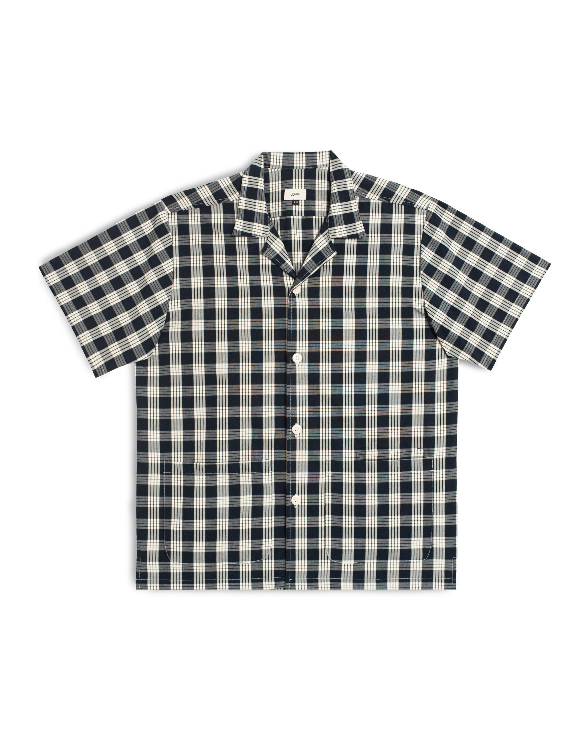 Front view of the Bather Men's Admiral Palaka Traveler Camp Shirt, featuring a traditional navy and white Polynesian plaid pattern, a relaxed boxy fit, and a classic open camp collar.