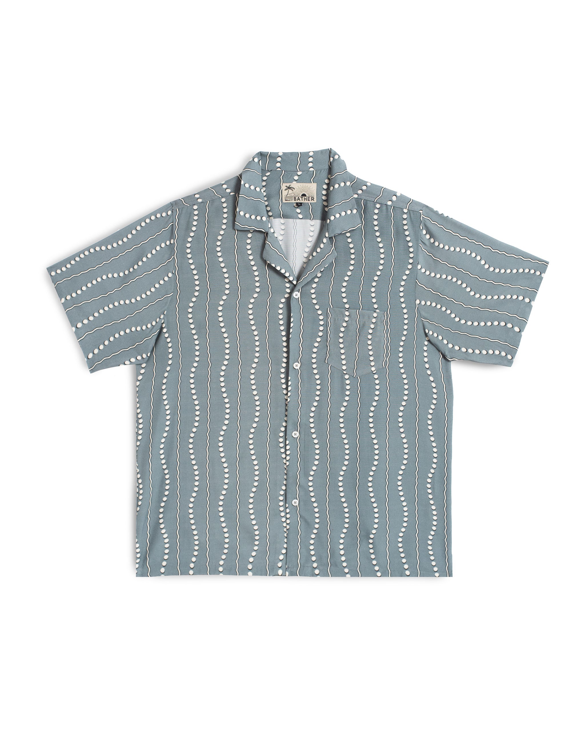 Front view of the Bather Men's Ash Tidal Current Camp Shirt, featuring a steel blue and white wavy vertical stripe pattern, a single chest pocket, and a classic open camp collar against a white background.