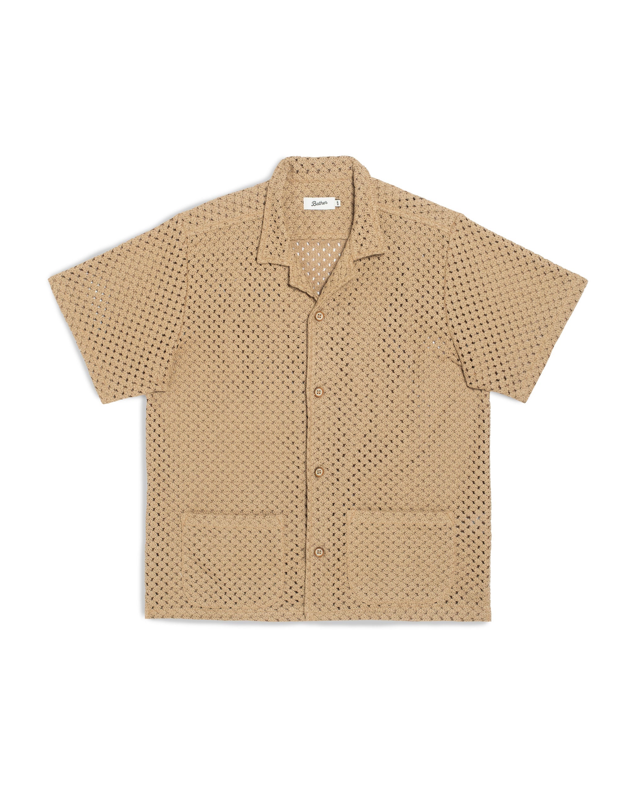 Front view of the Bather Men's Beach Mesh Traveler Shirt, featuring a natural-colored Japanese cotton crocheted mesh fabric, two front patch pockets, and a classic camp collar against a white background.