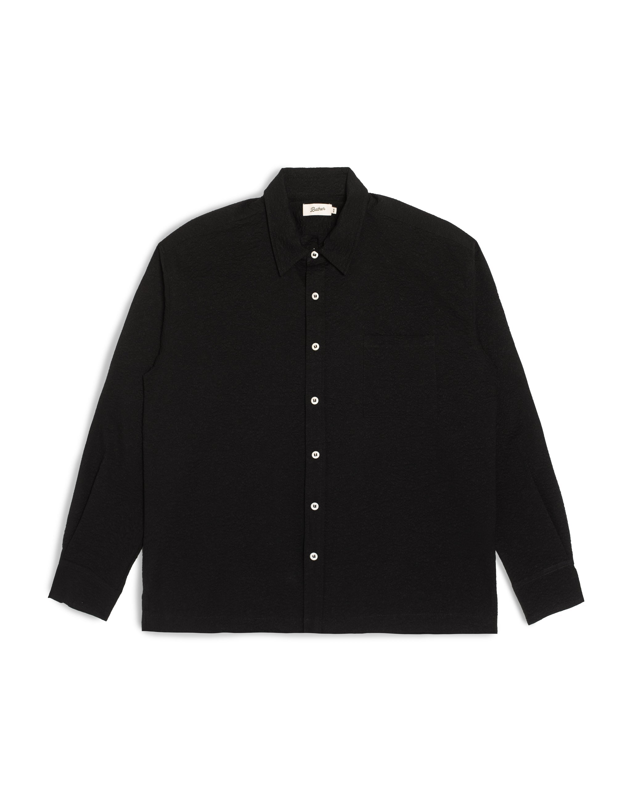 Front view of the Bather Men's Black Ripple Leisure Shirt, featuring a lightweight 100% cotton Japanese fabric with a subtle seersucker texture, a classic collar, and white buttons against a white background.