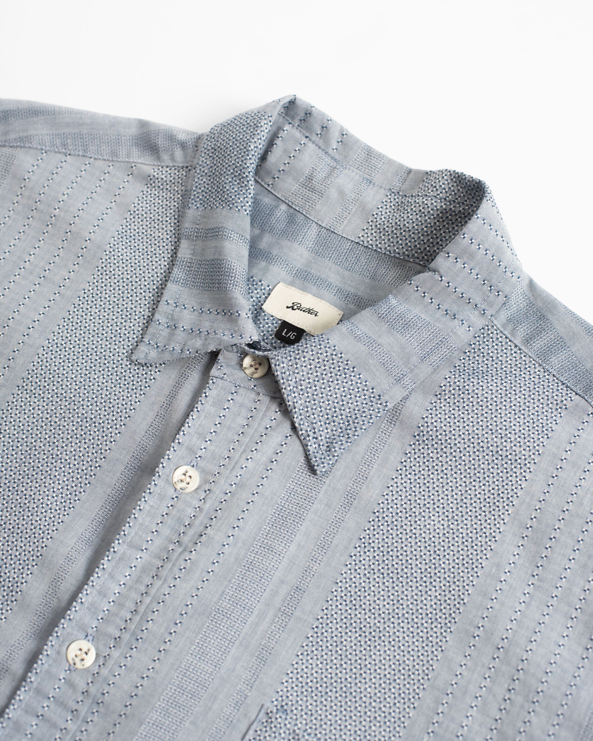 Detailed texture of the 280 GSM Japanese milled mid-weight plaid flannel fabric on the Bather Men's Buoy overshirt.