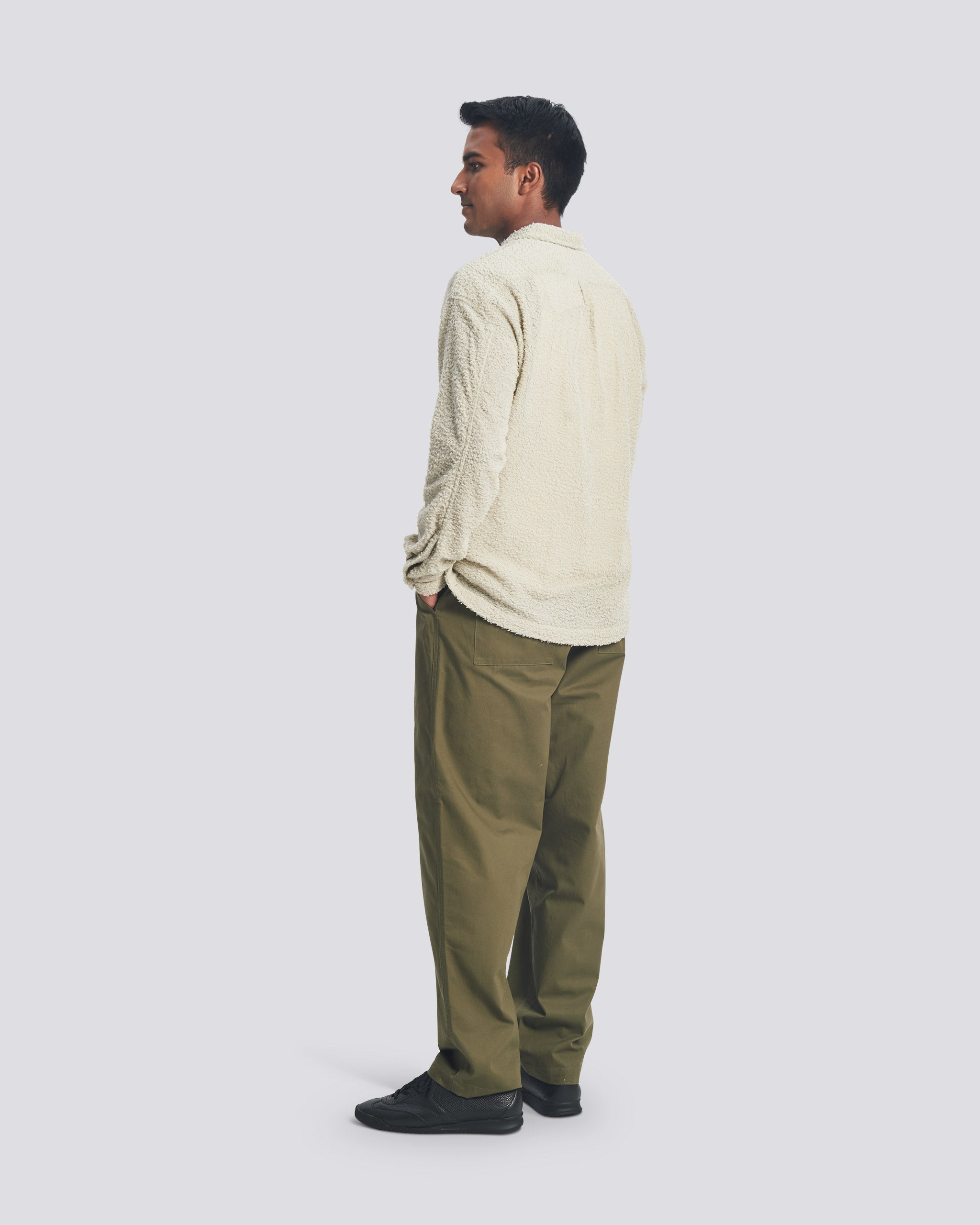 Side view of male model wearing the Bather Men's Cloud Shaggy Leisure Shirt in a relaxed fit, showcasing the unique fuzzy texture and straight hem for a modern casual look.