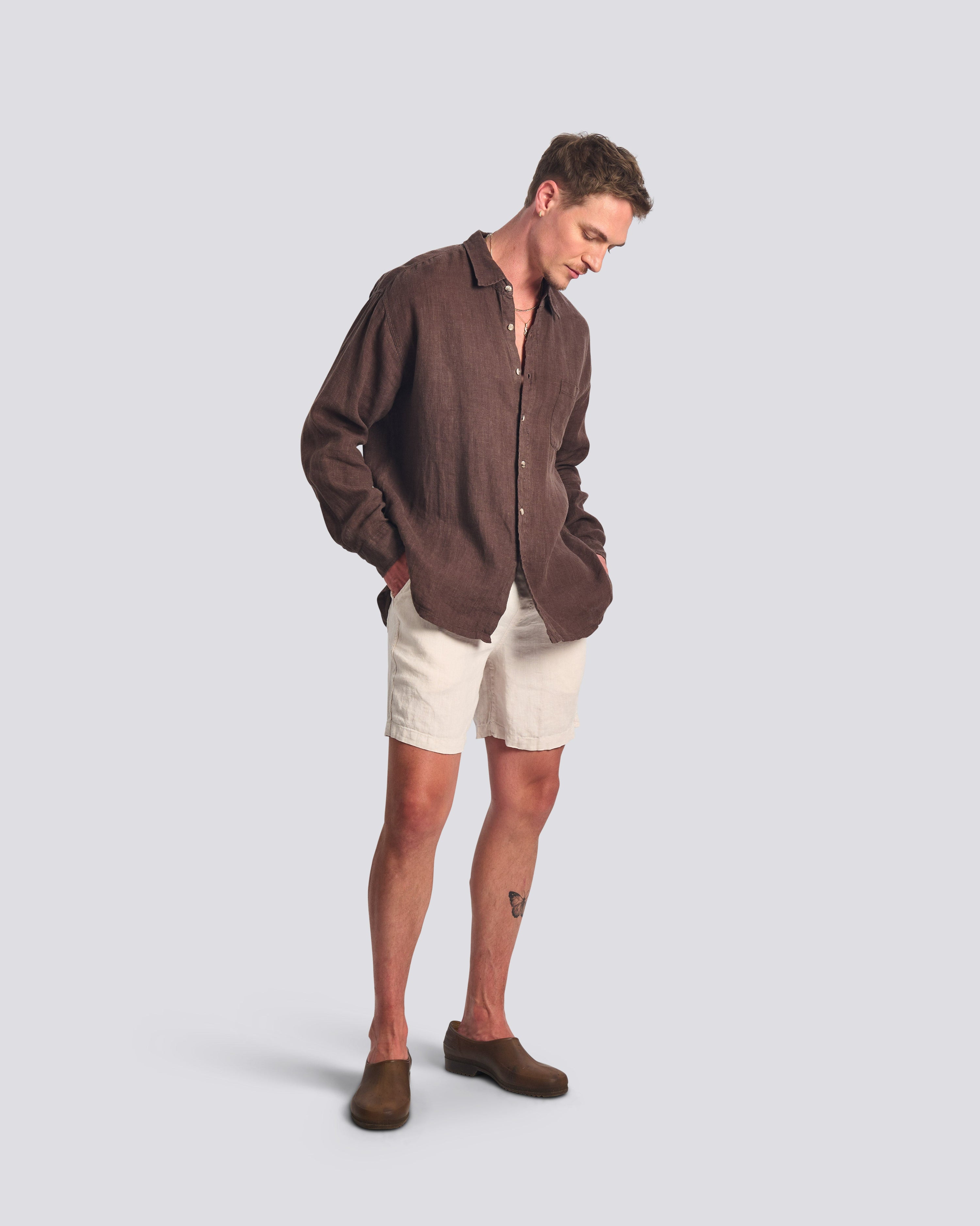 Male model wearing the Bather Men's Espresso Linen Leisure Shirt in a relaxed fit, showcasing the lightweight brown linen and white linen leisure shorts for a sophisticated summer look 