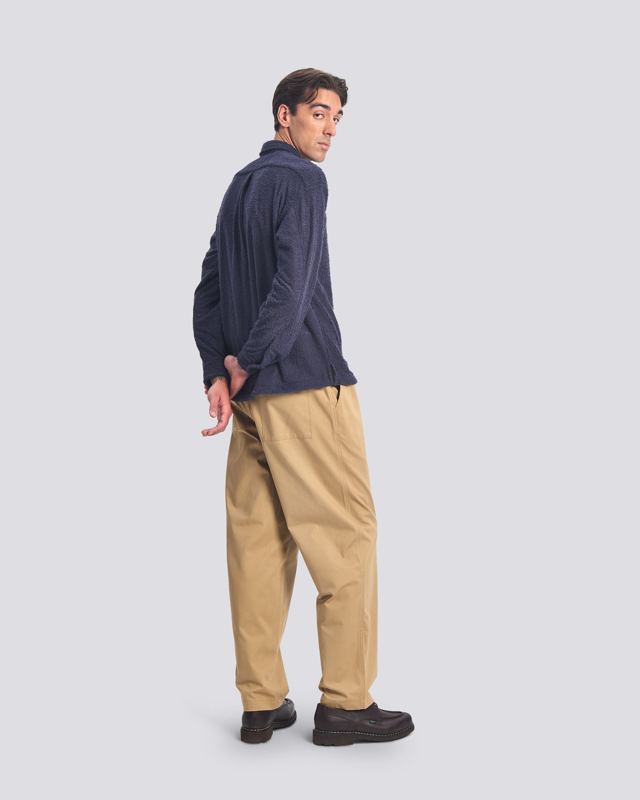 Side-rear view of the Bather Men's Whale Shaggy Leisure Shirt in dark navy blue, showcasing the regular fit and the unique fuzzy texture of the shaggy fabric on a model wearing tan chinos.