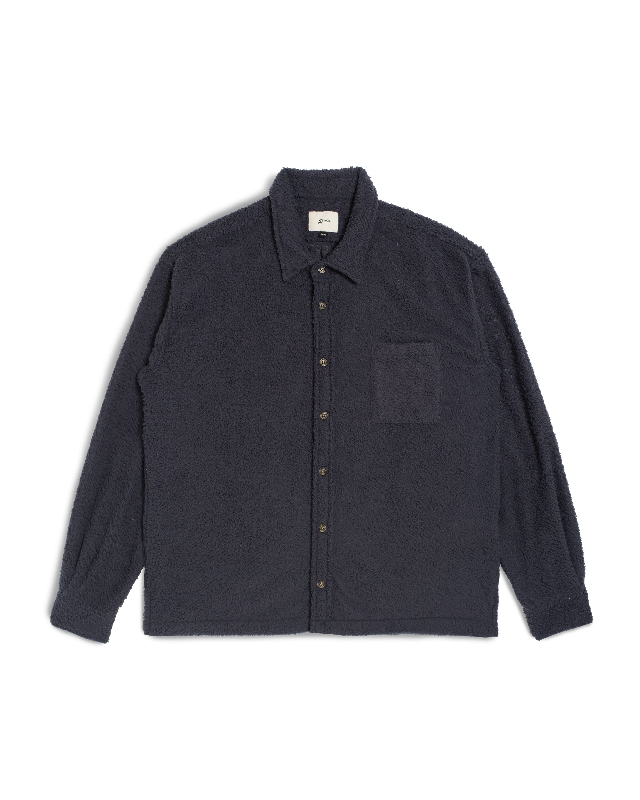 Bather Men’s Whale Shaggy Leisure Shirt in a dark navy blue, featuring a long-sleeve silhouette with a fuzzy, textured shaggy finish, a classic collar, and a chest pocket on a white background.