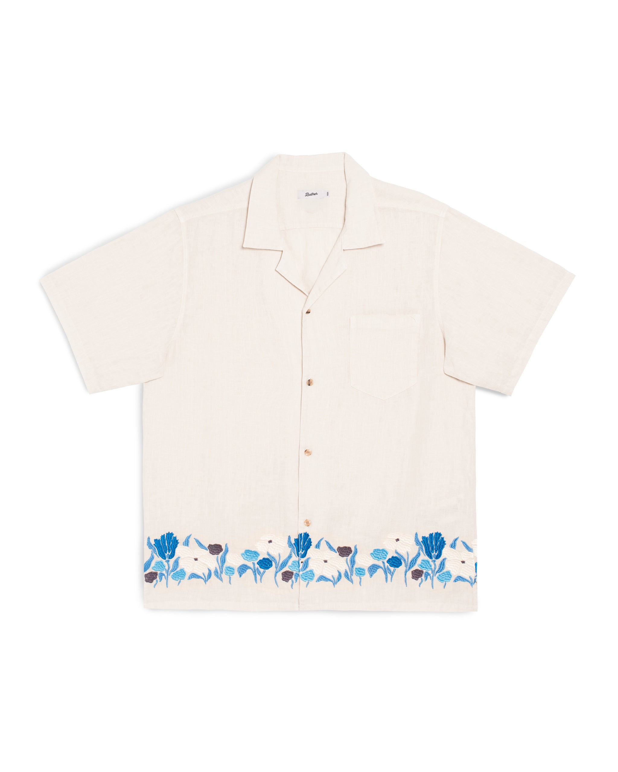 Beige shirt with blue floral embroidery on a white background