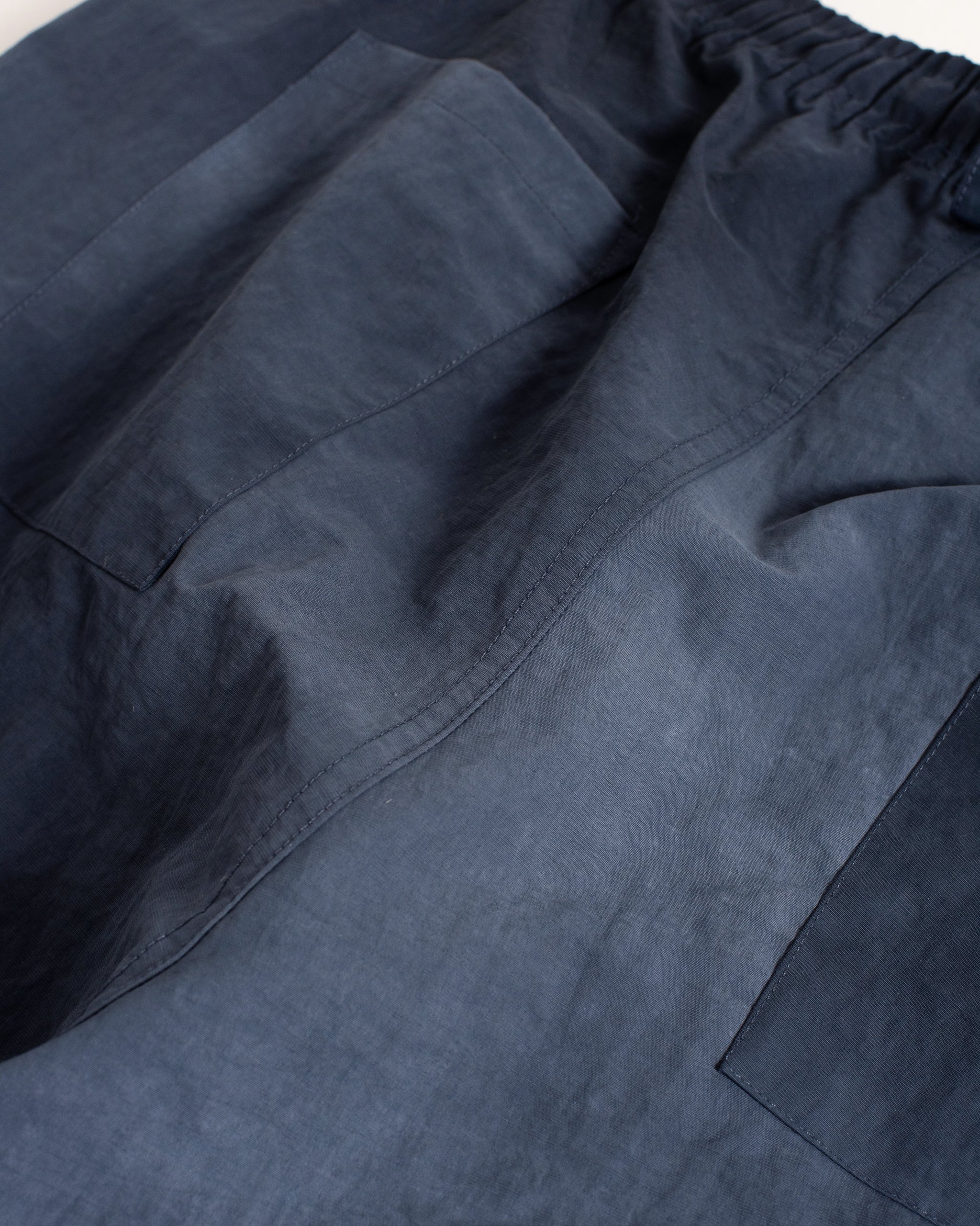 Bather men's navy over dyed nylon pant detail shot on grey background