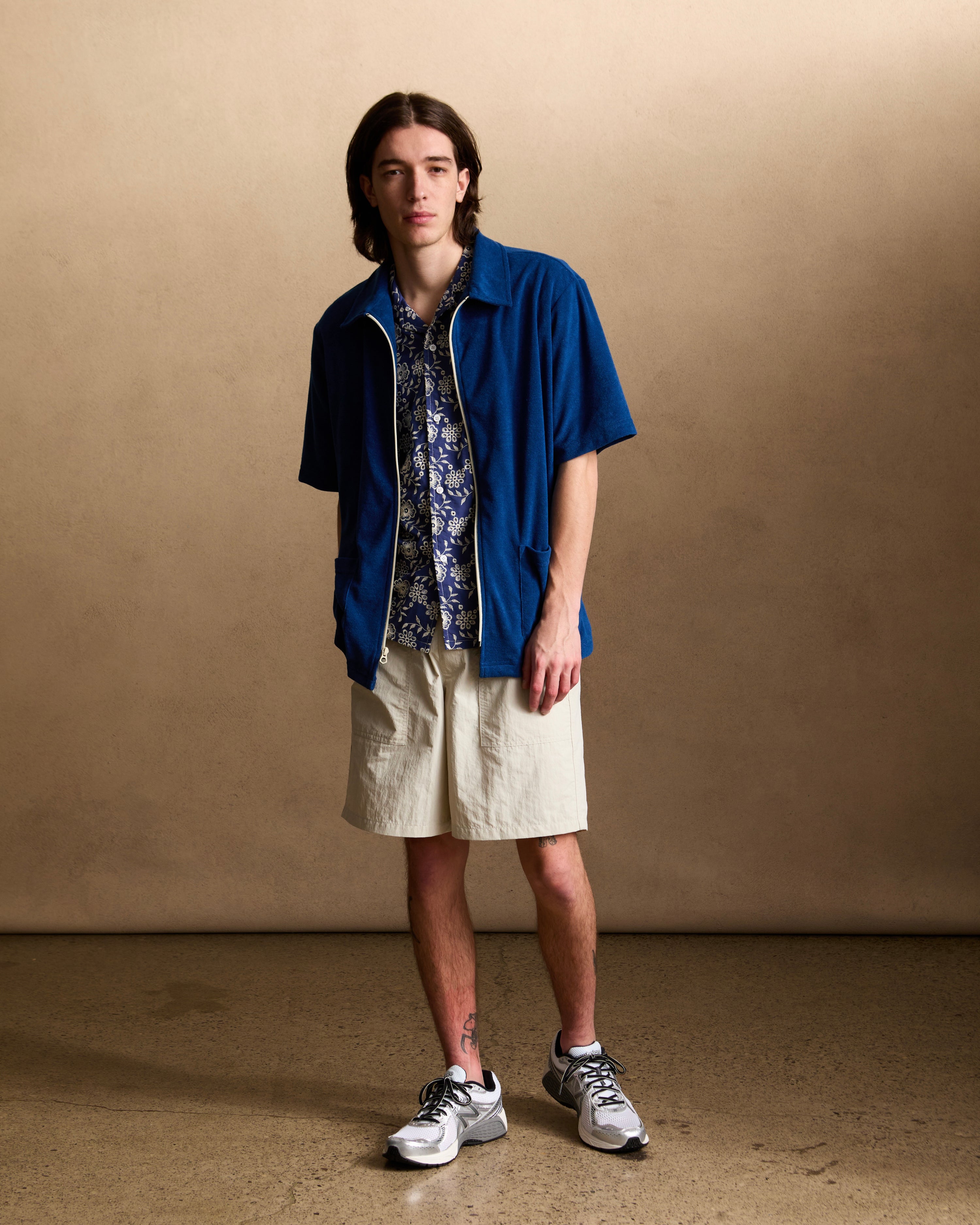 Model wearing Cream utility shorts in Ripstop nylon fabric