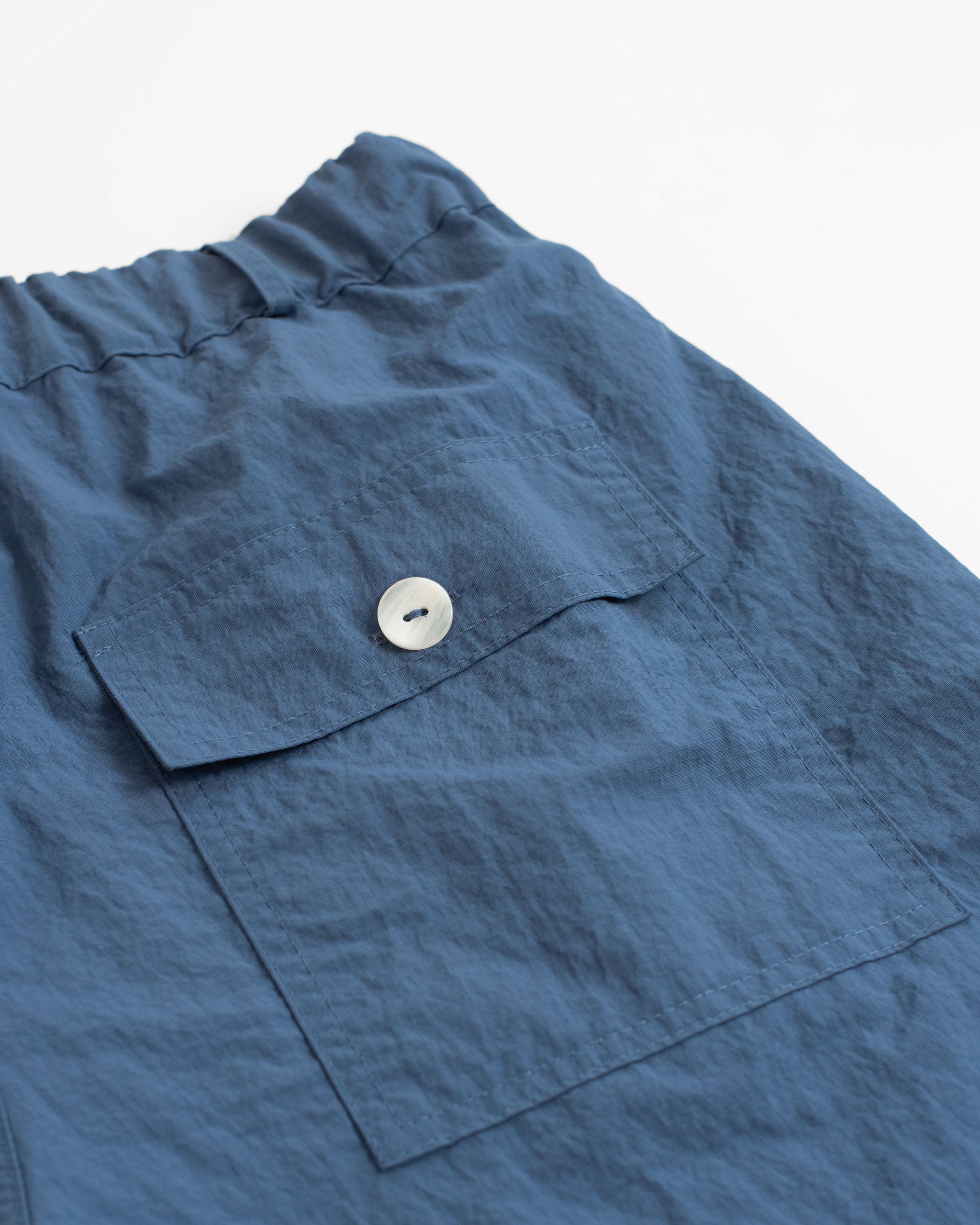 back pocket shot of Bather men's Solid blue fatigue shorts in ripstop nylon