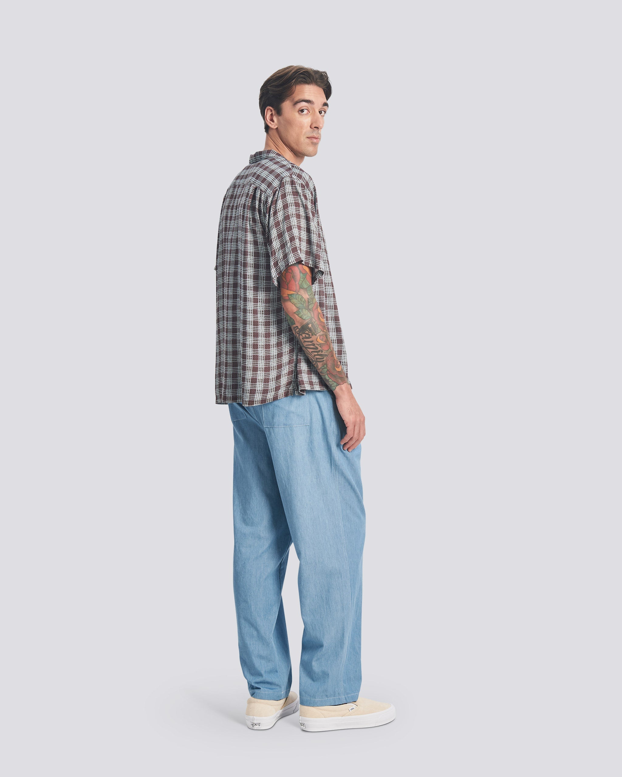 Back view of model wearing Bather men's lightwash denim pant