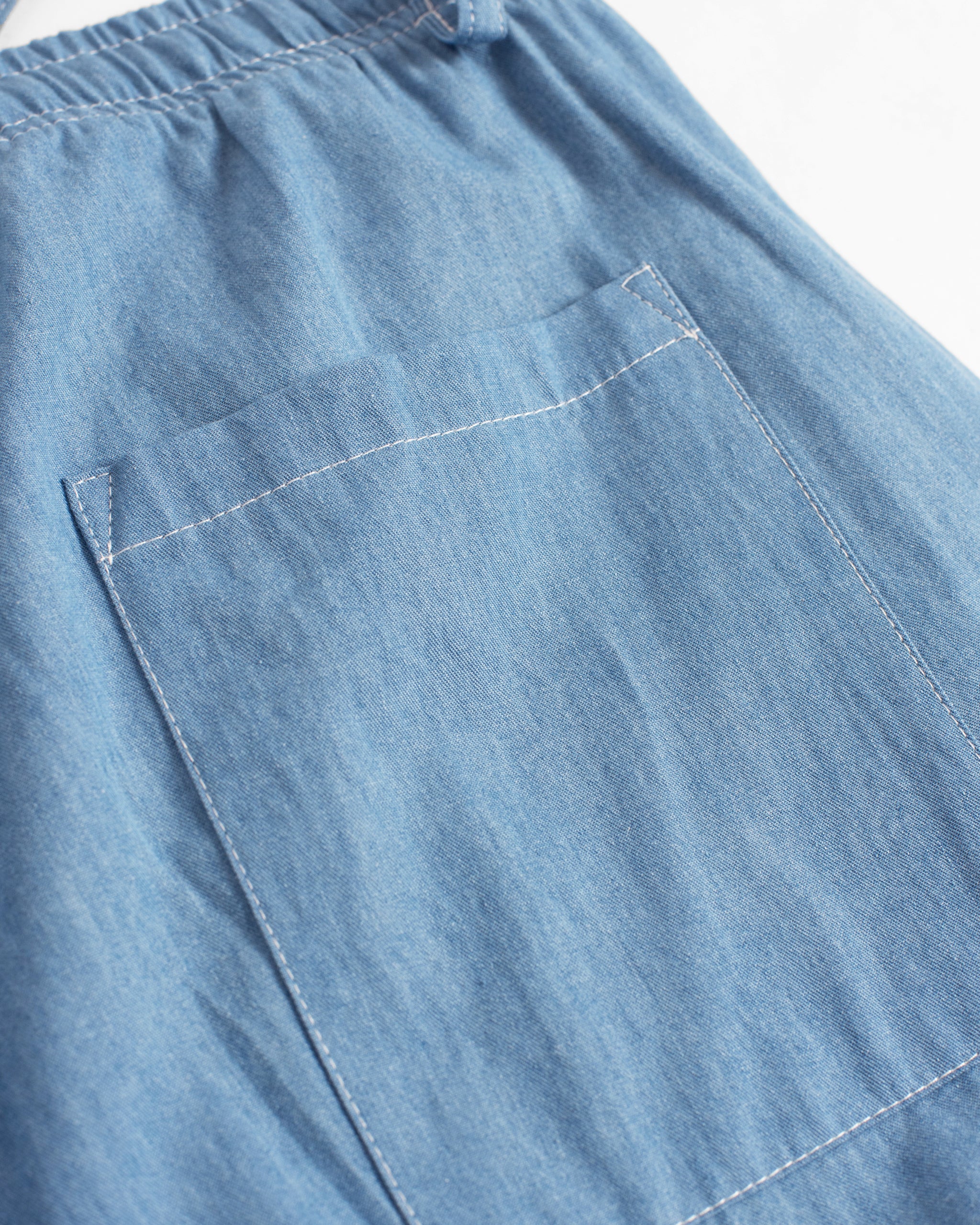 Closeup of back pocket on Bather men's lightwash denim pant