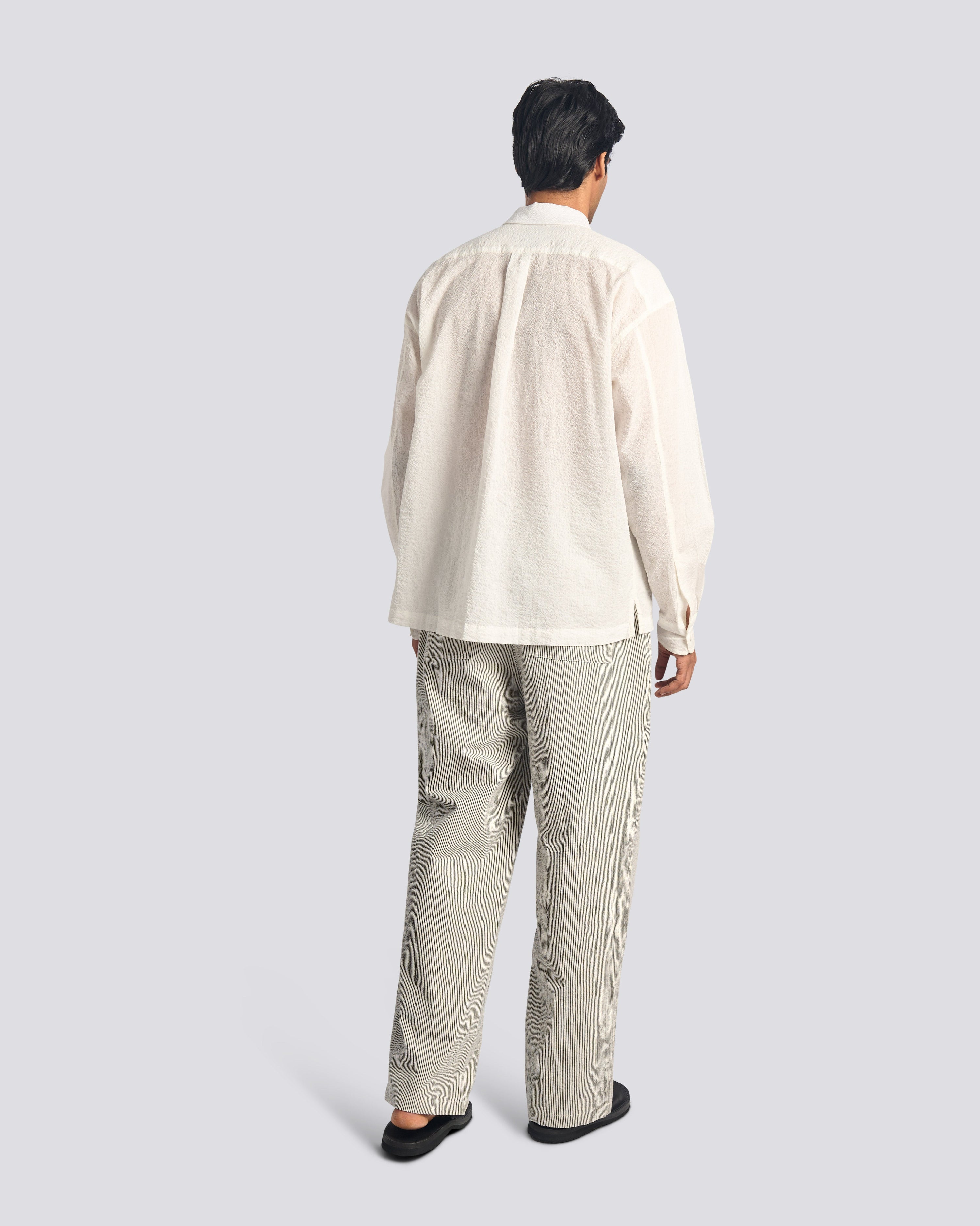 Rear view of the Bather Men's navy pinstripe trousers.