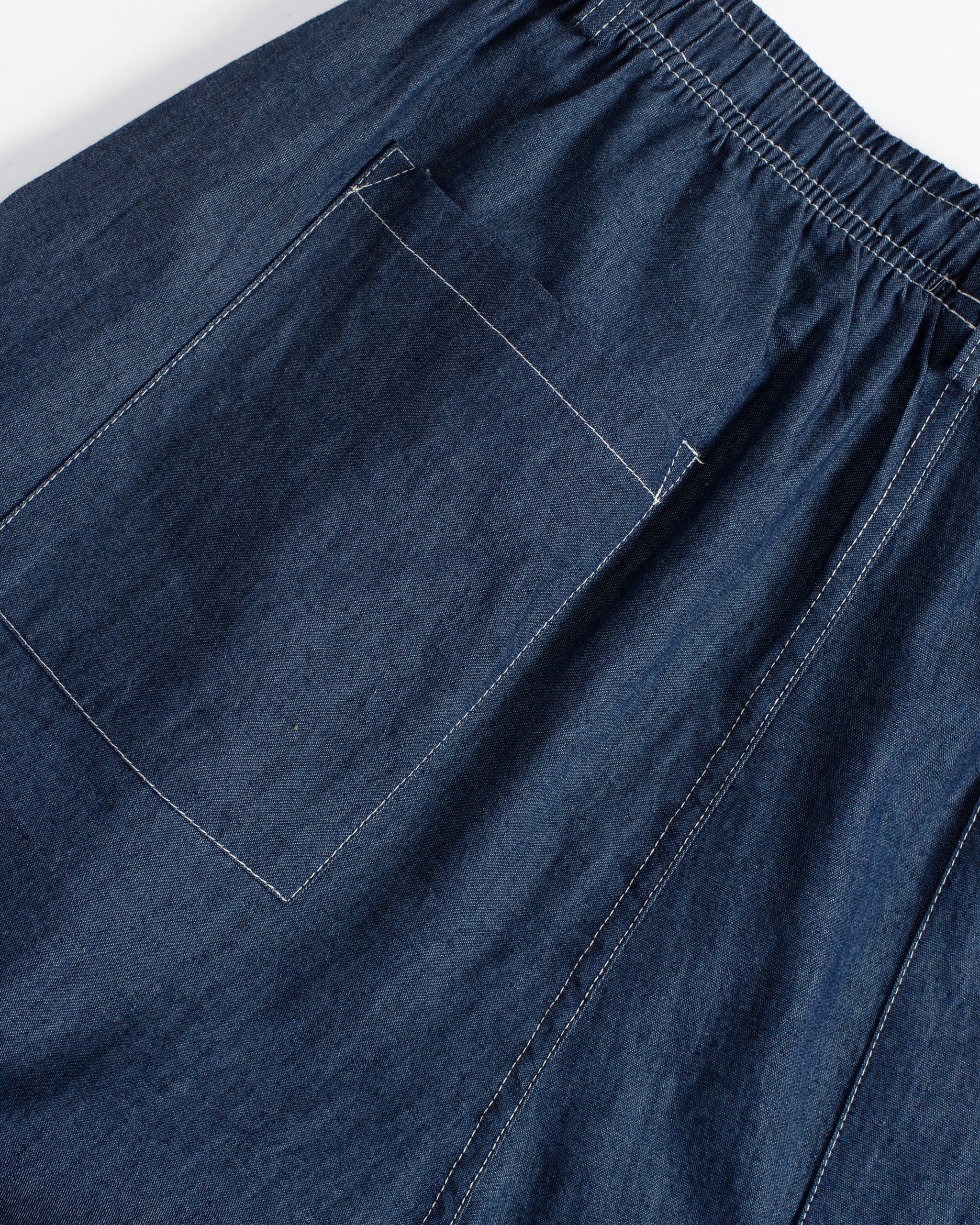 Closeup back pocket detail of Bather men's dark wash denim drawstring pant