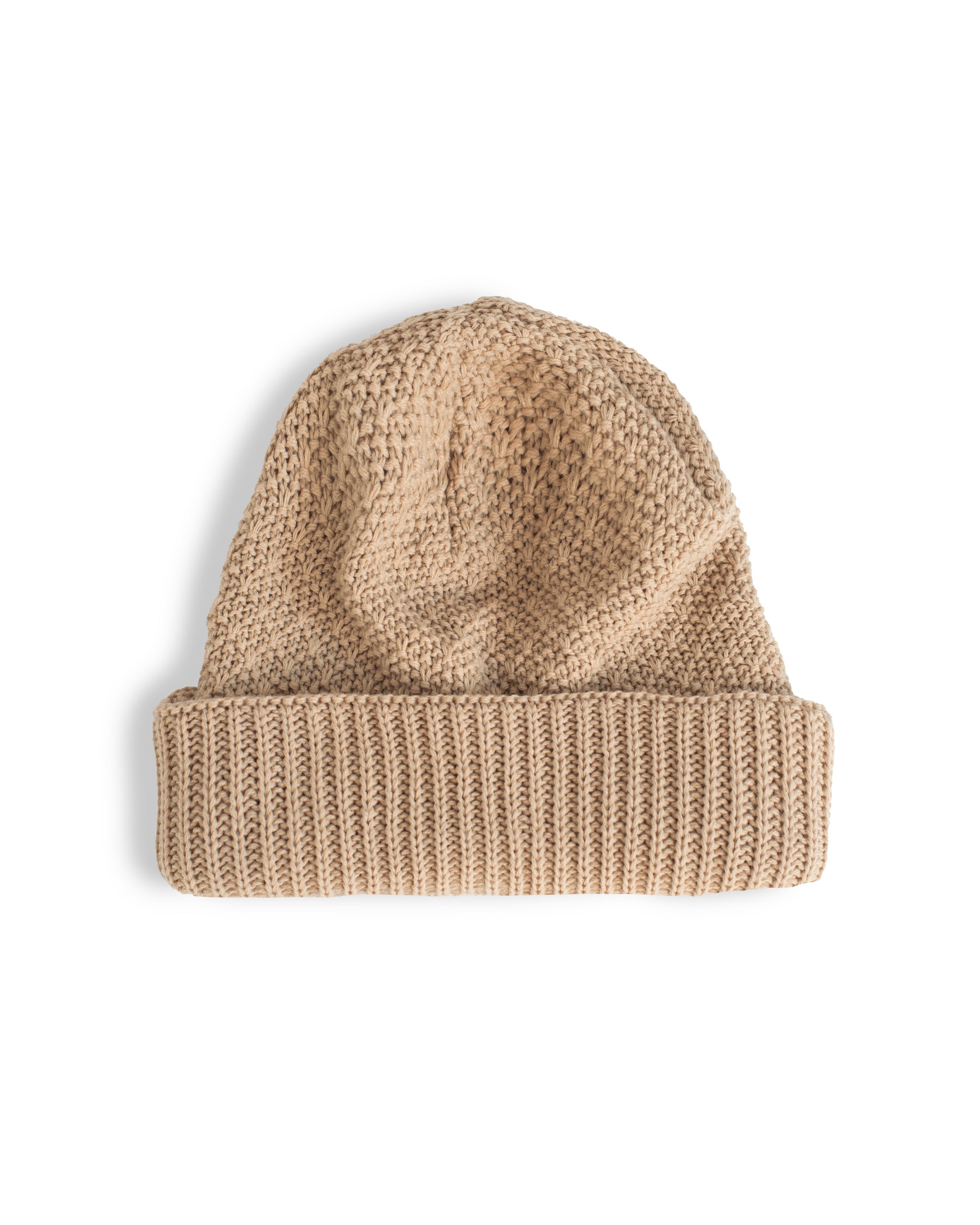 Knit beige beanie on white background 