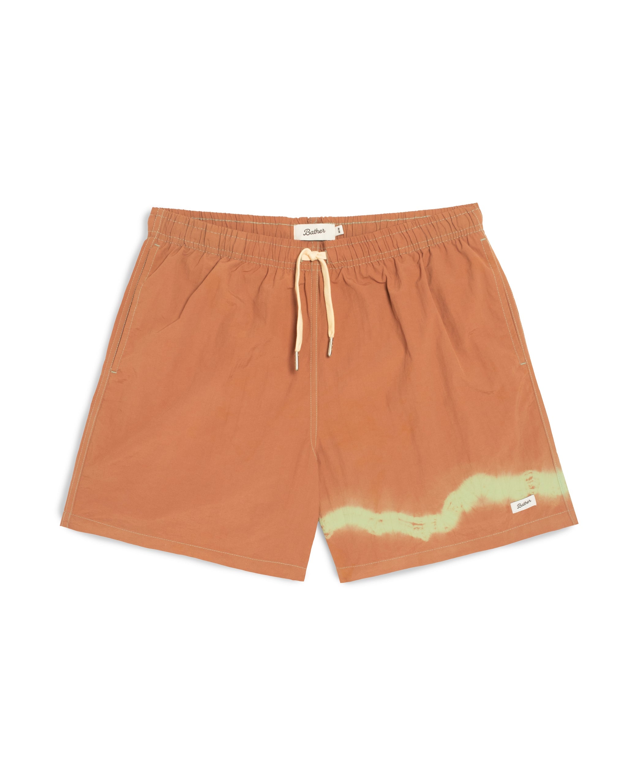 Orange shorts with a yellow design on a white background