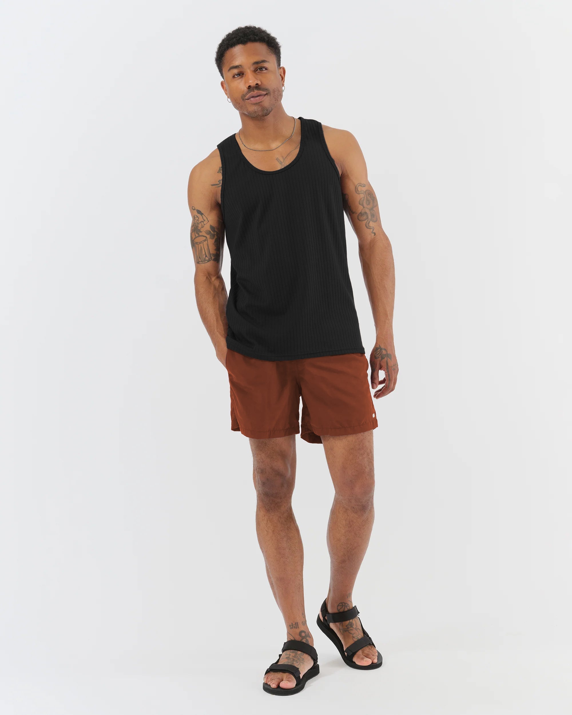 Man wearing Bather brown swim trunks with Bather black tank top