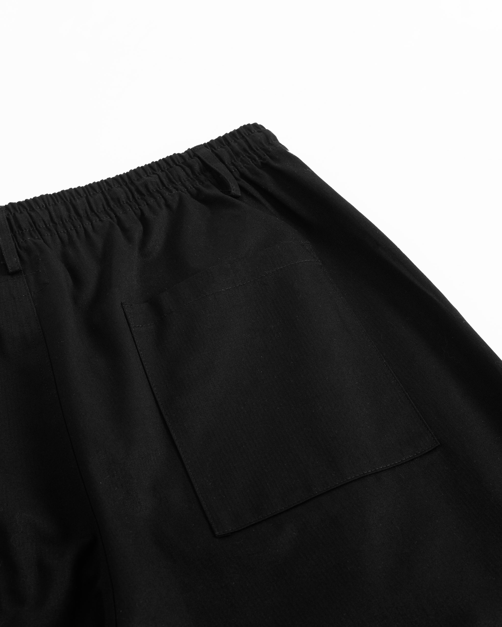 Close-up of back pocket on Bather men's black drawstring pants