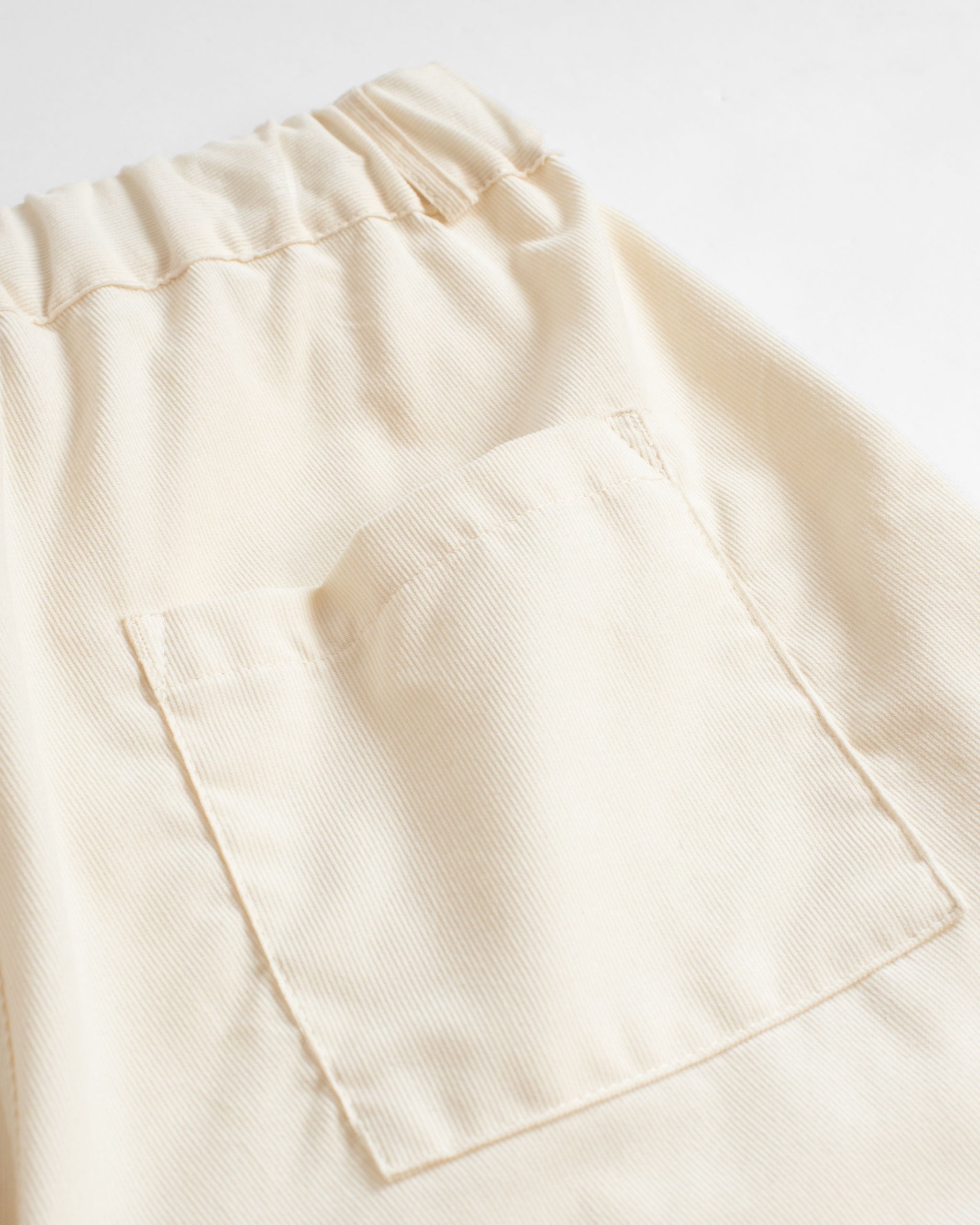 Back pocket shot of Bather men's cream cotton corduroy short