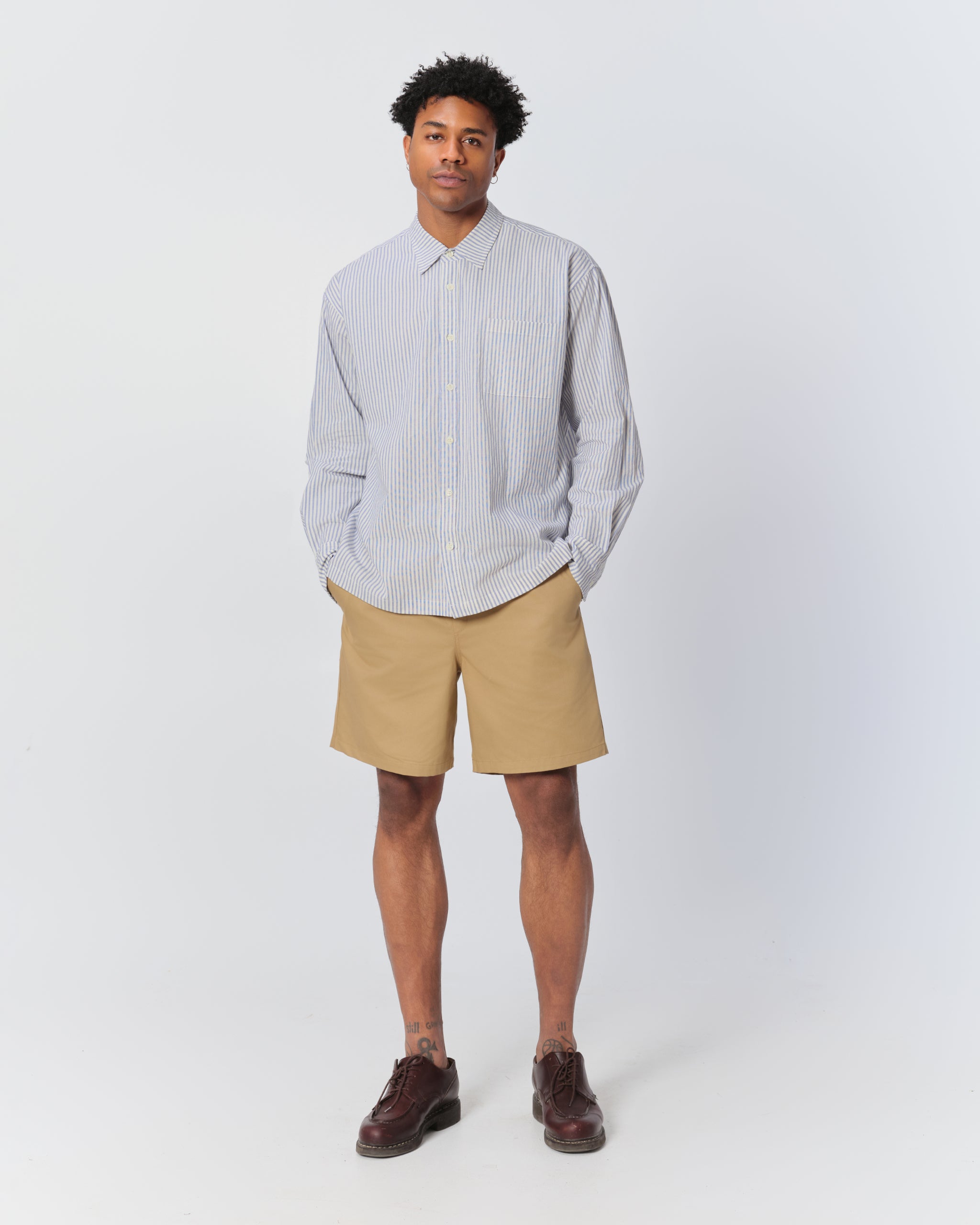 Model wearing Bather men's khaki herringbone shorts with drawstring from the front on a white background
