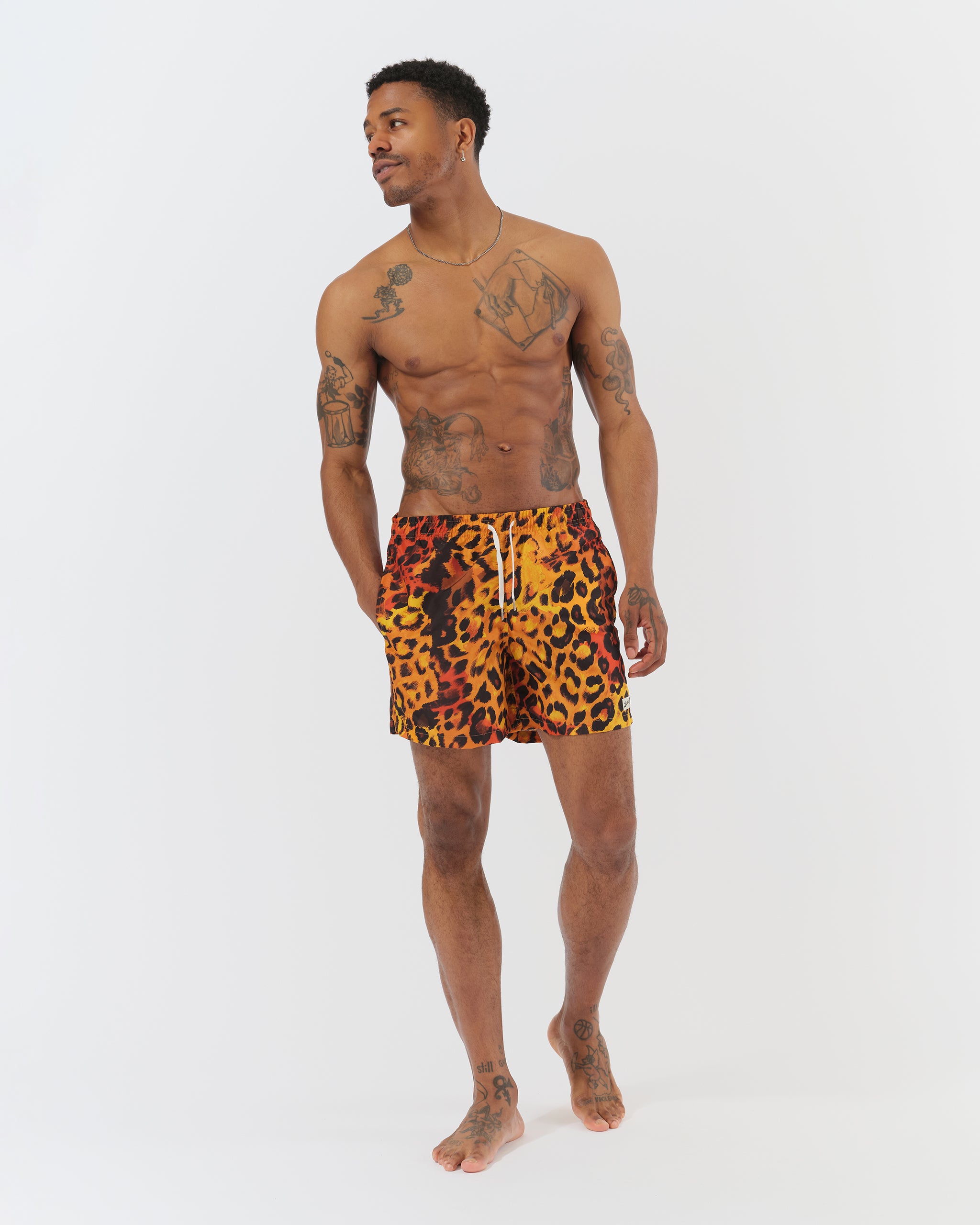 orange Bather swim trunk with a black leopard pattern on model