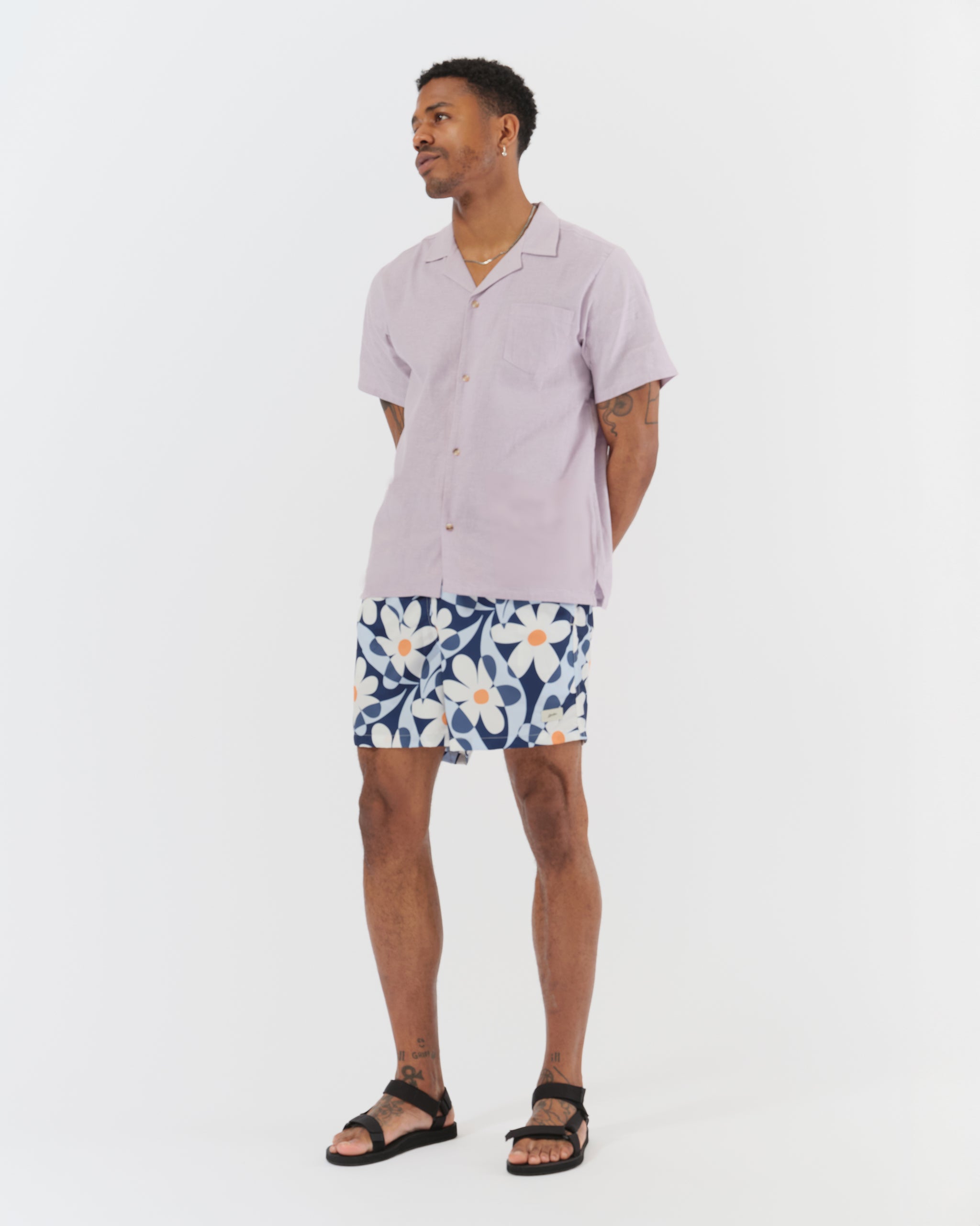 bather swim trunks with abstract daisy pattern on model