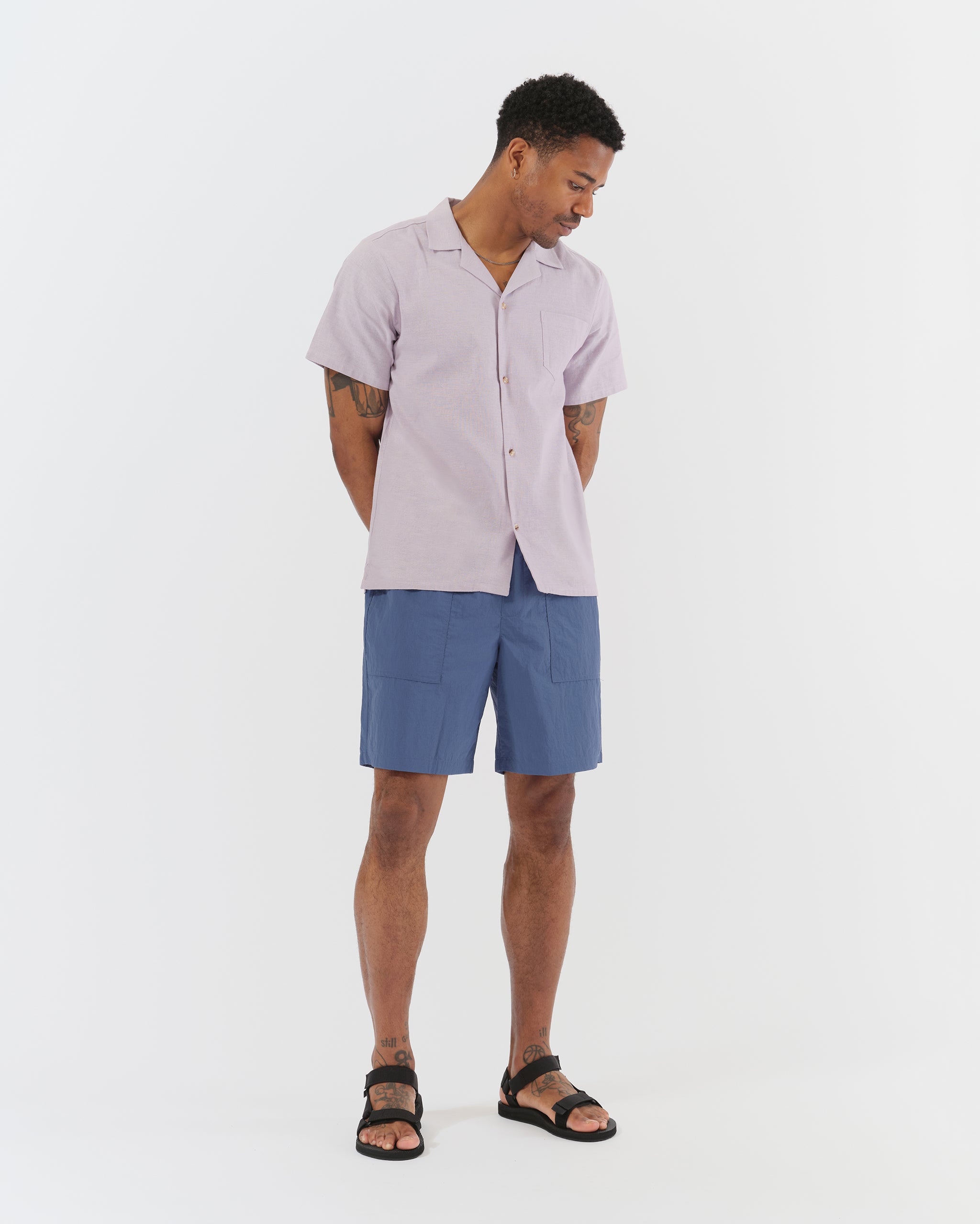 Solid blue utility shorts in ripstop nylon on model