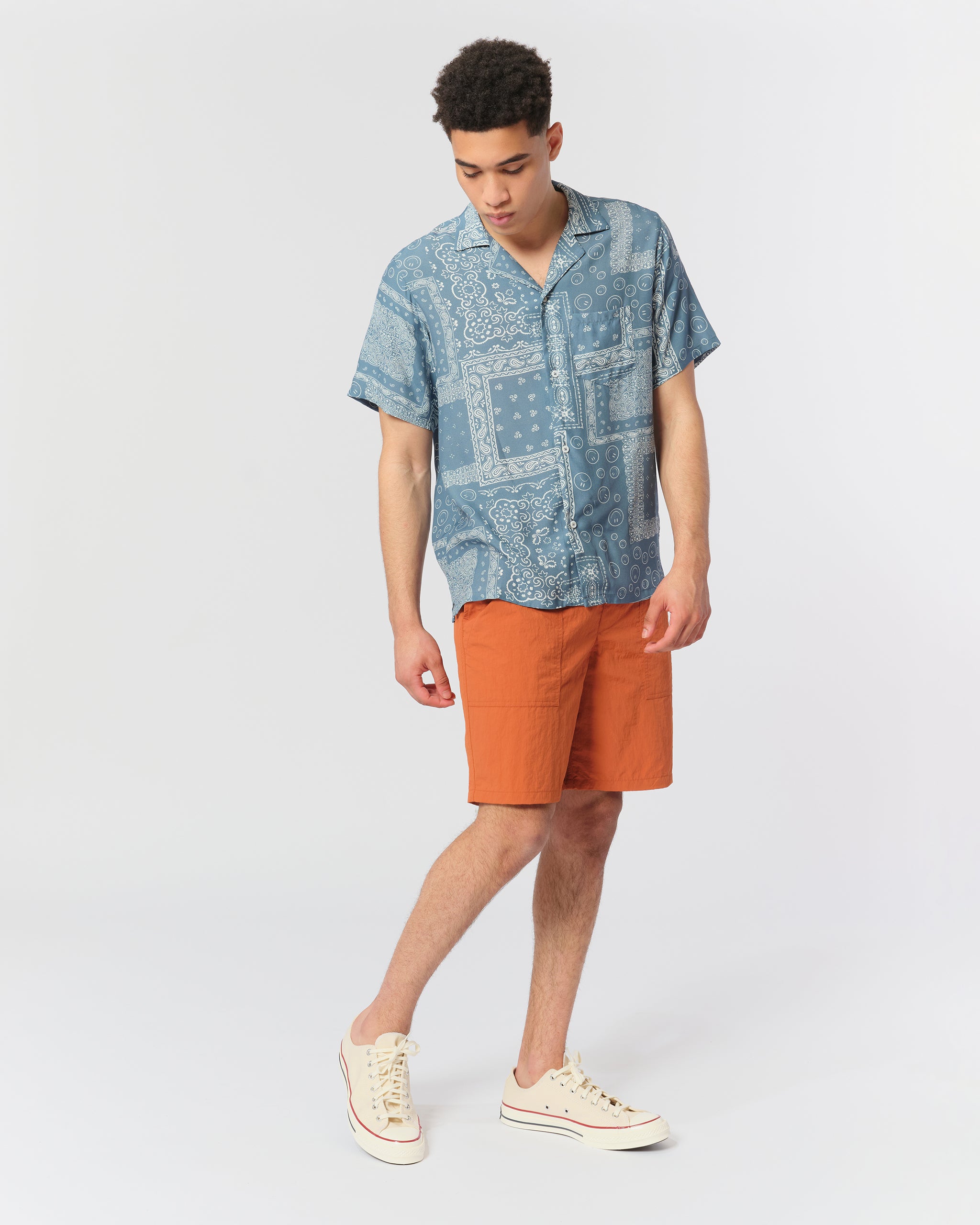 Model wearing Bather men's solid orange nylon utility shorts with elasticized waist