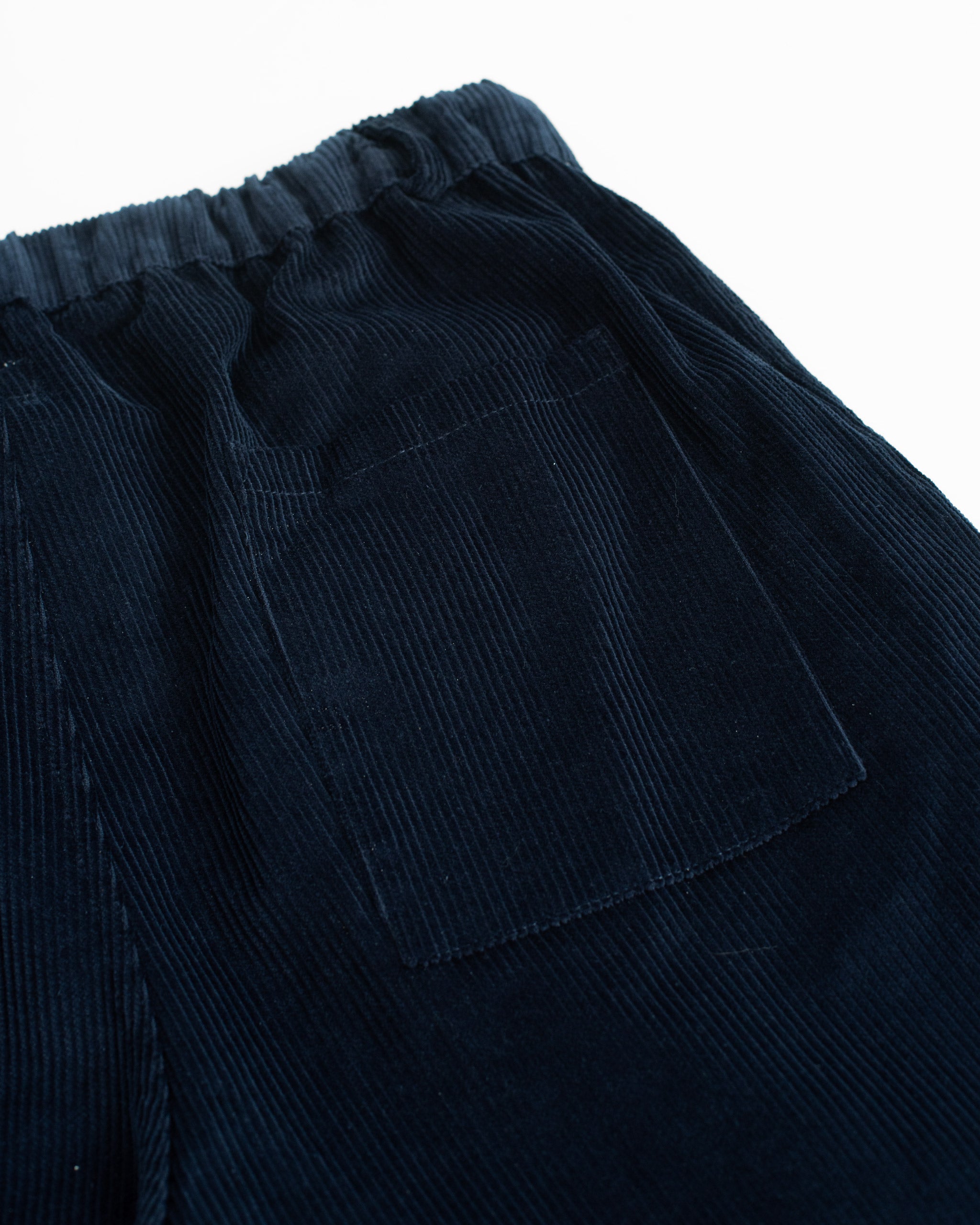 Closeup pocket detail of Bather men's dark blue corduroy drawstring pant