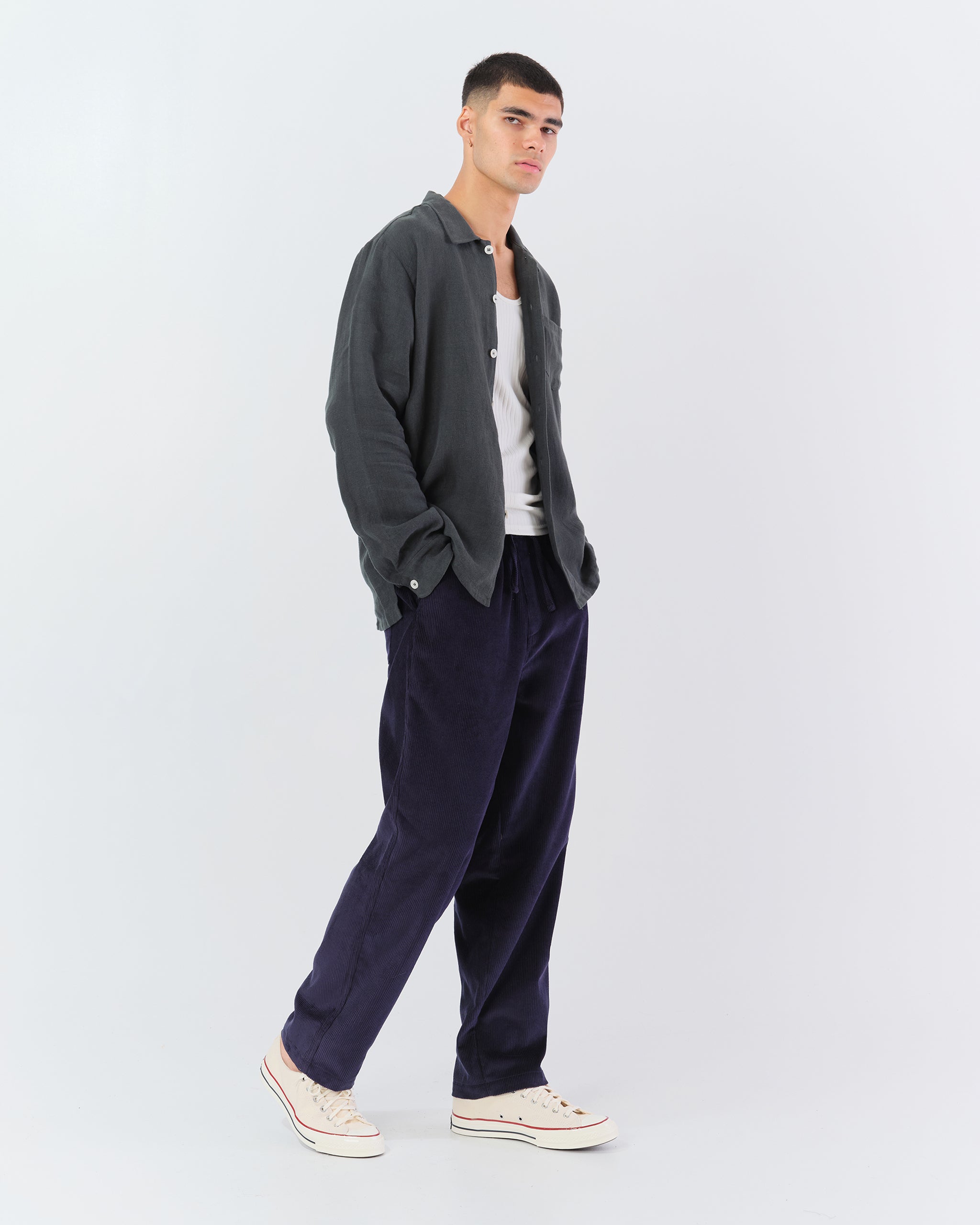 Model wearing Bather men's dark blue corduroy drawstring pants