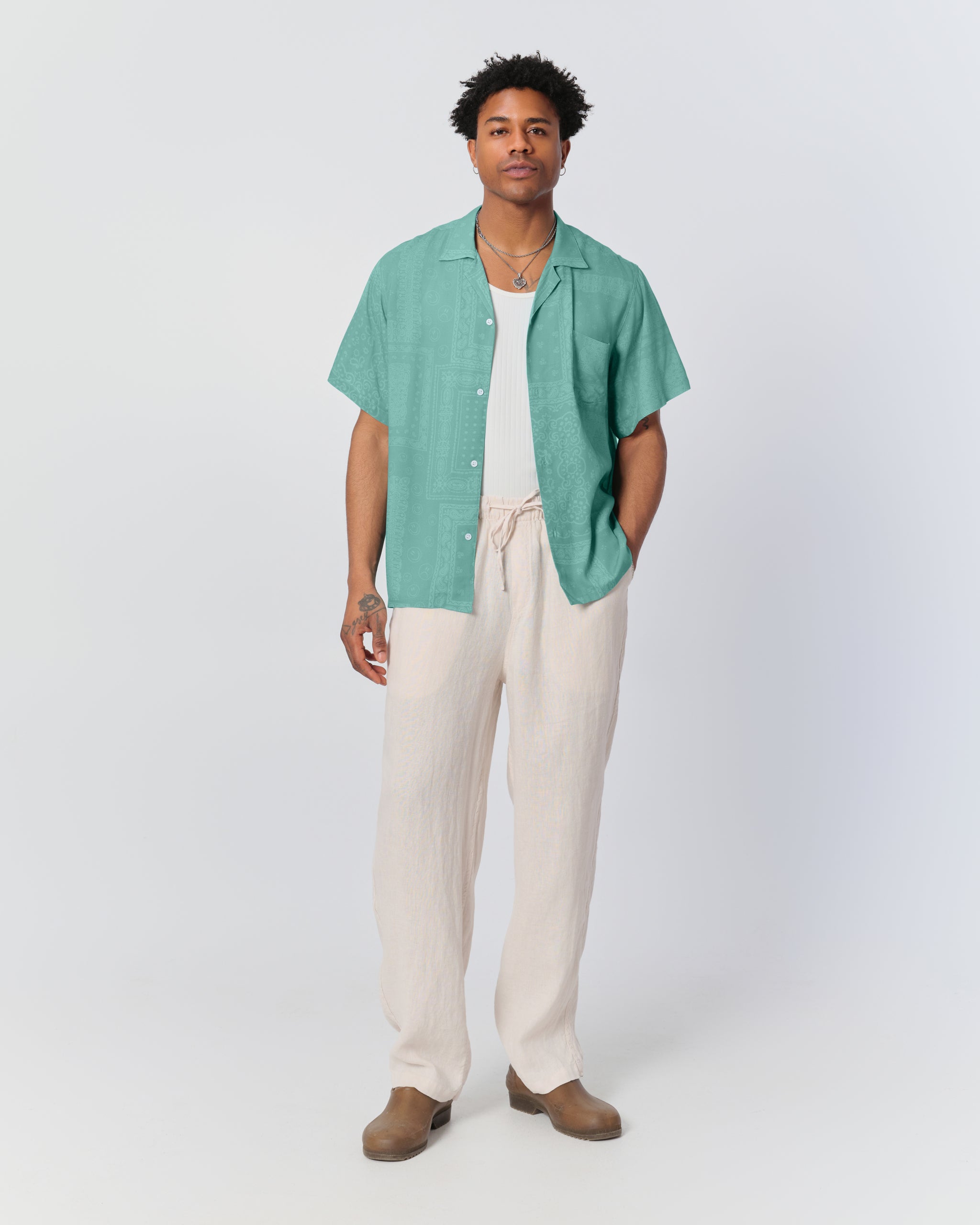 Model wearing Bather men's off-white linen drawstring pants