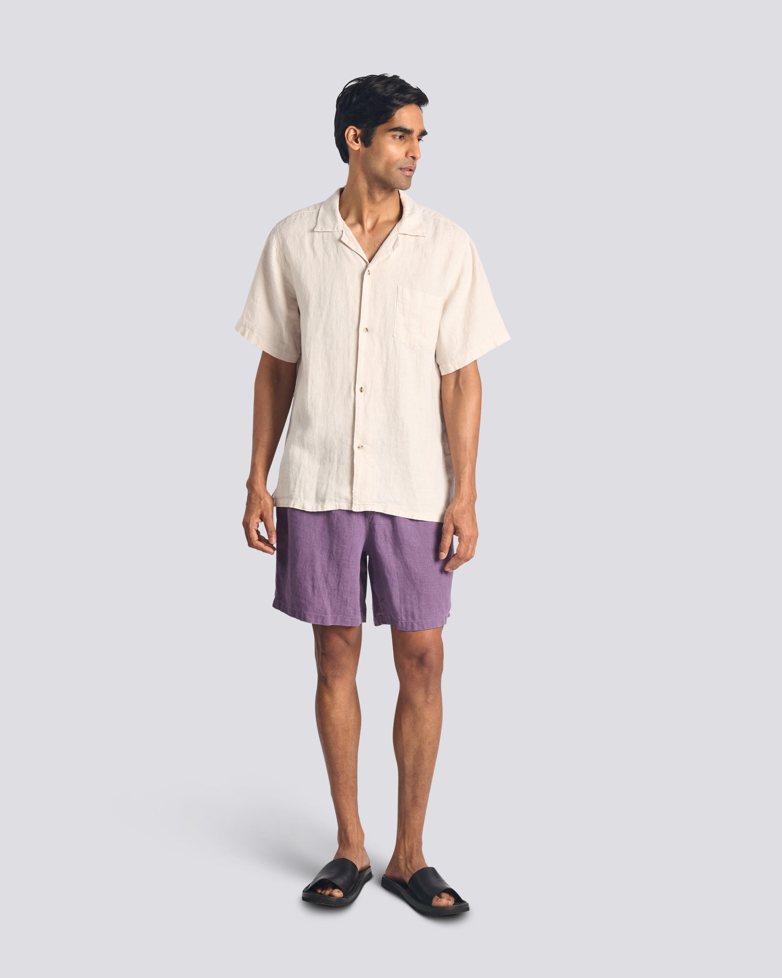 Model wearing Bather men's purple linen shorts with drawstring from the front on a white background