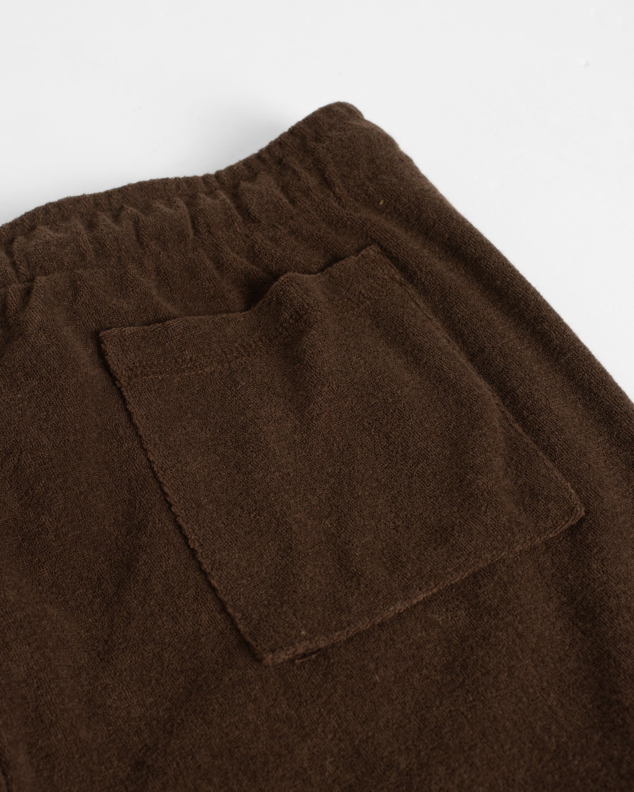 Closeup shot of back pocket of Bather men's dark brown towel terry short
