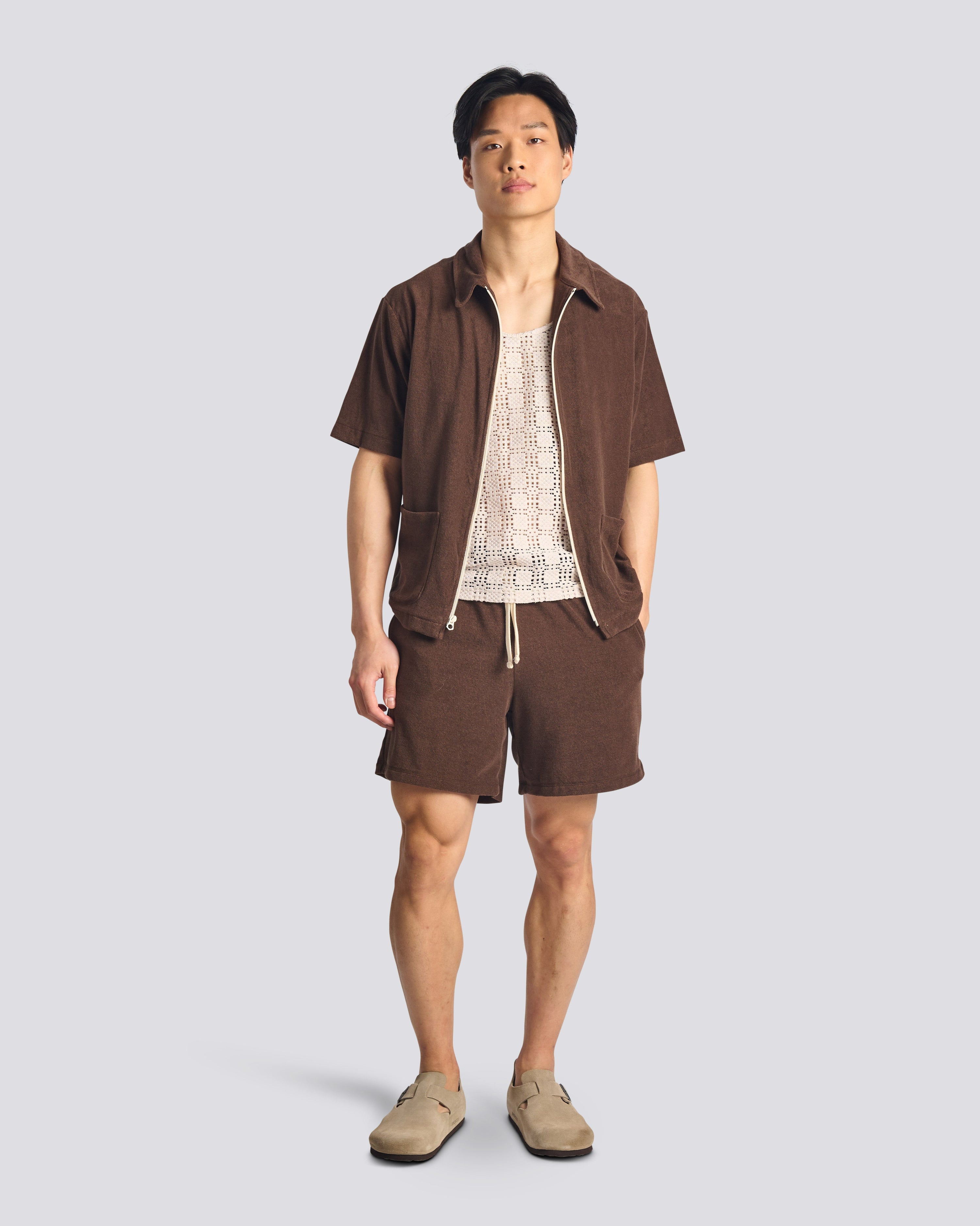 Model wearing Bather men's dark brown towel terry short with drawstring