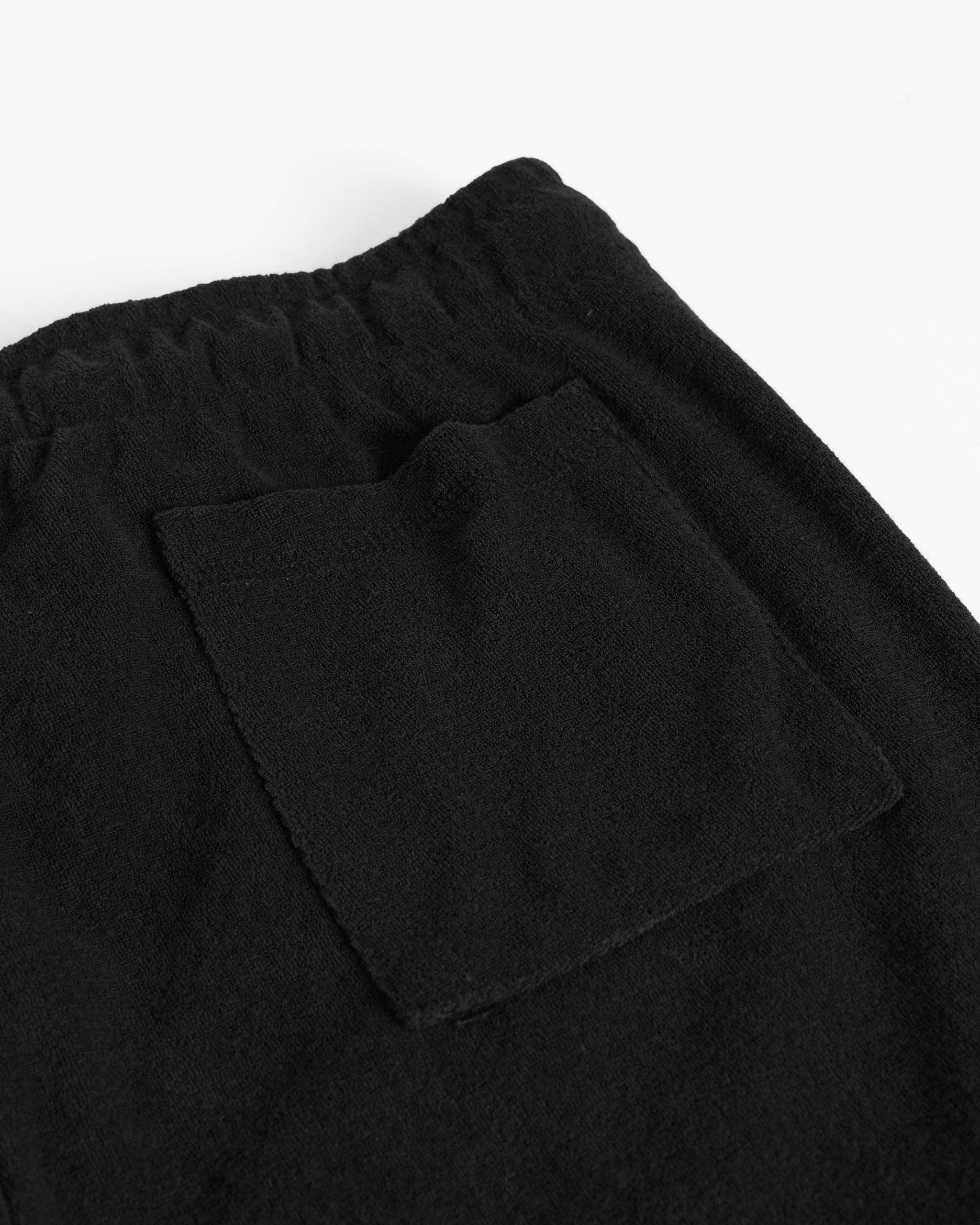 Closeup detail of back pocket of Bather men's black towel terry short 
