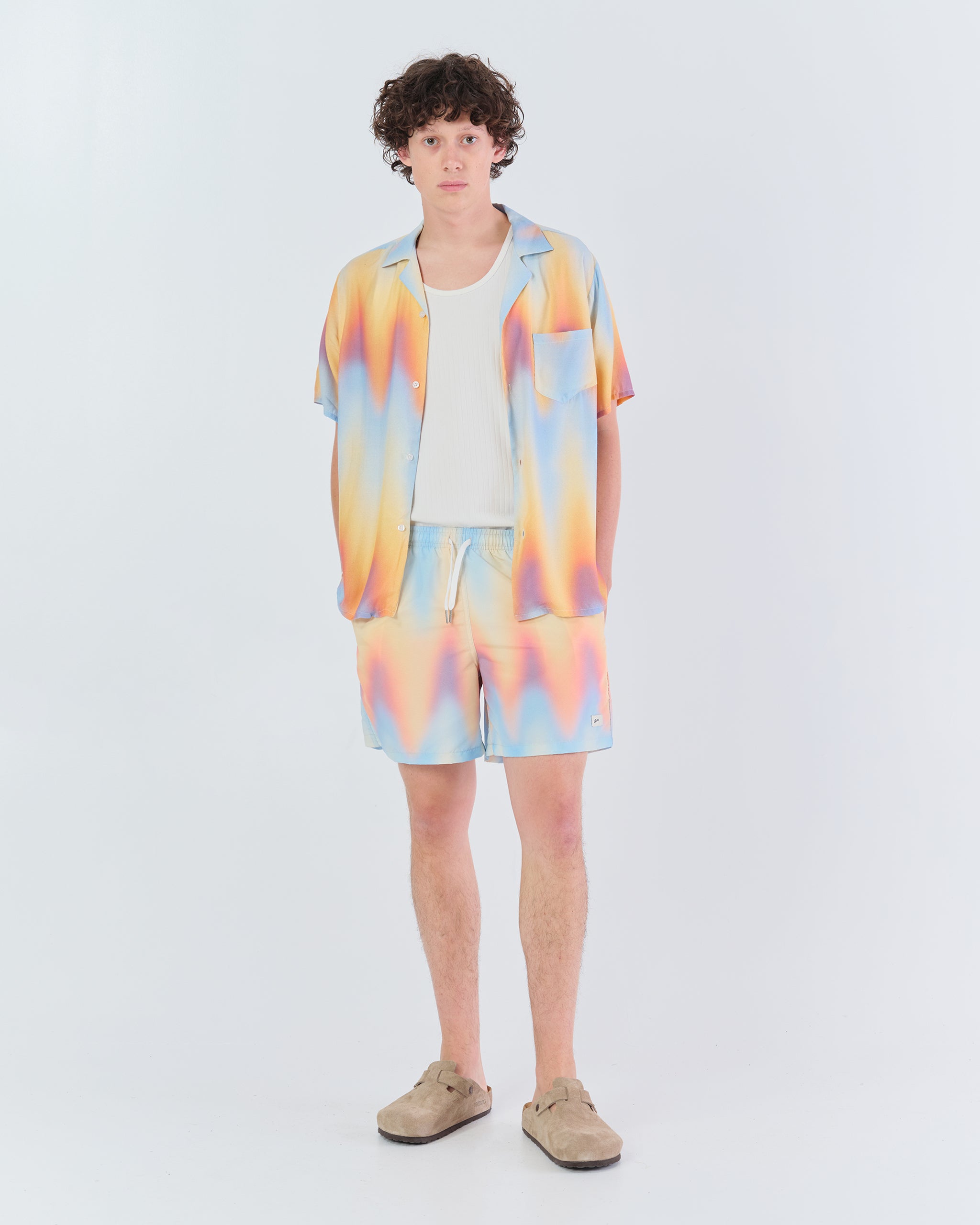 man wearing sunset set clothing afterglow print shirt and pant