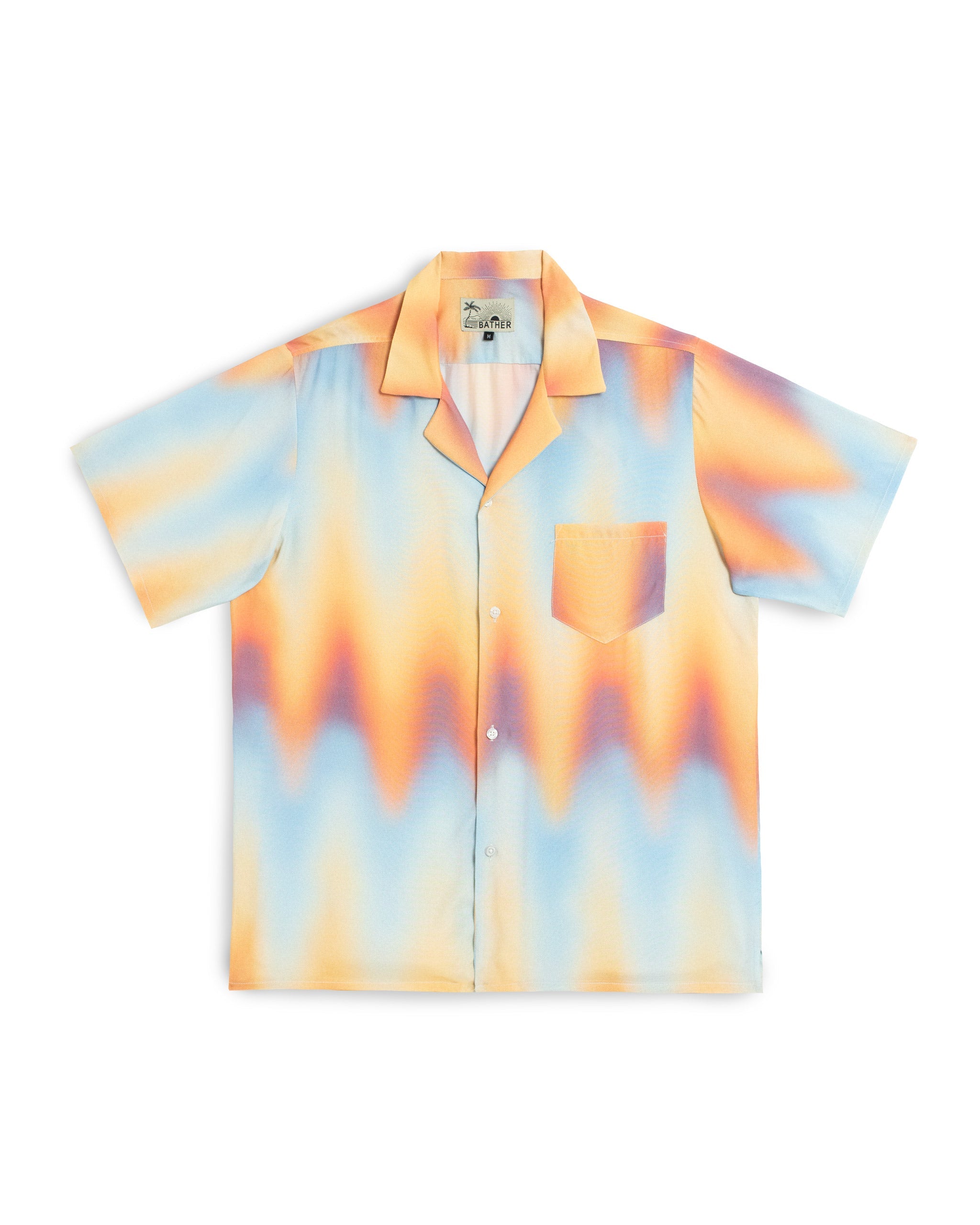 Short-sleeve shirt with a tie-dye pattern in orange, blue, and yellow on a white background.