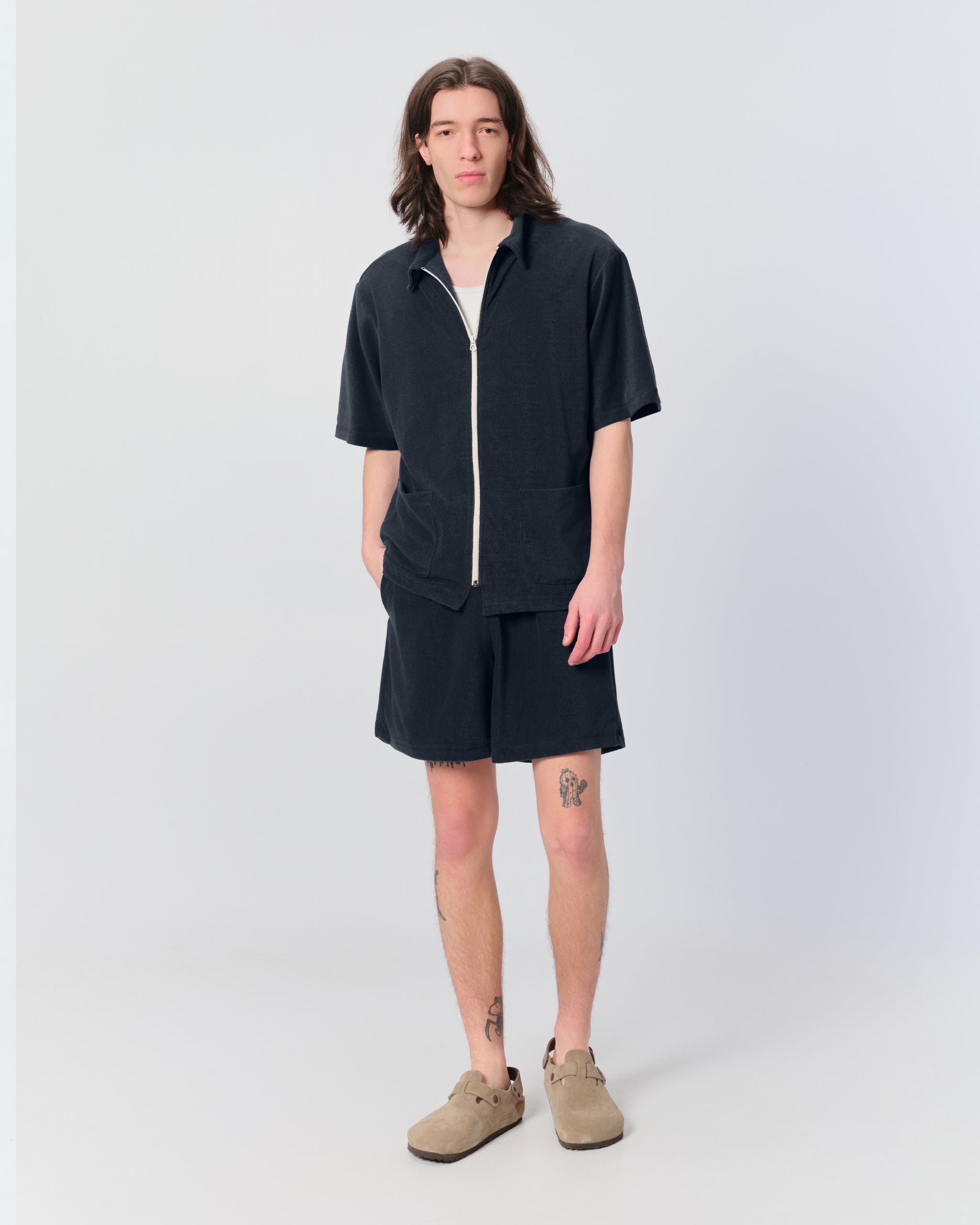 Model wearing Bather men's dark blue towel terry short with drawstring from the front