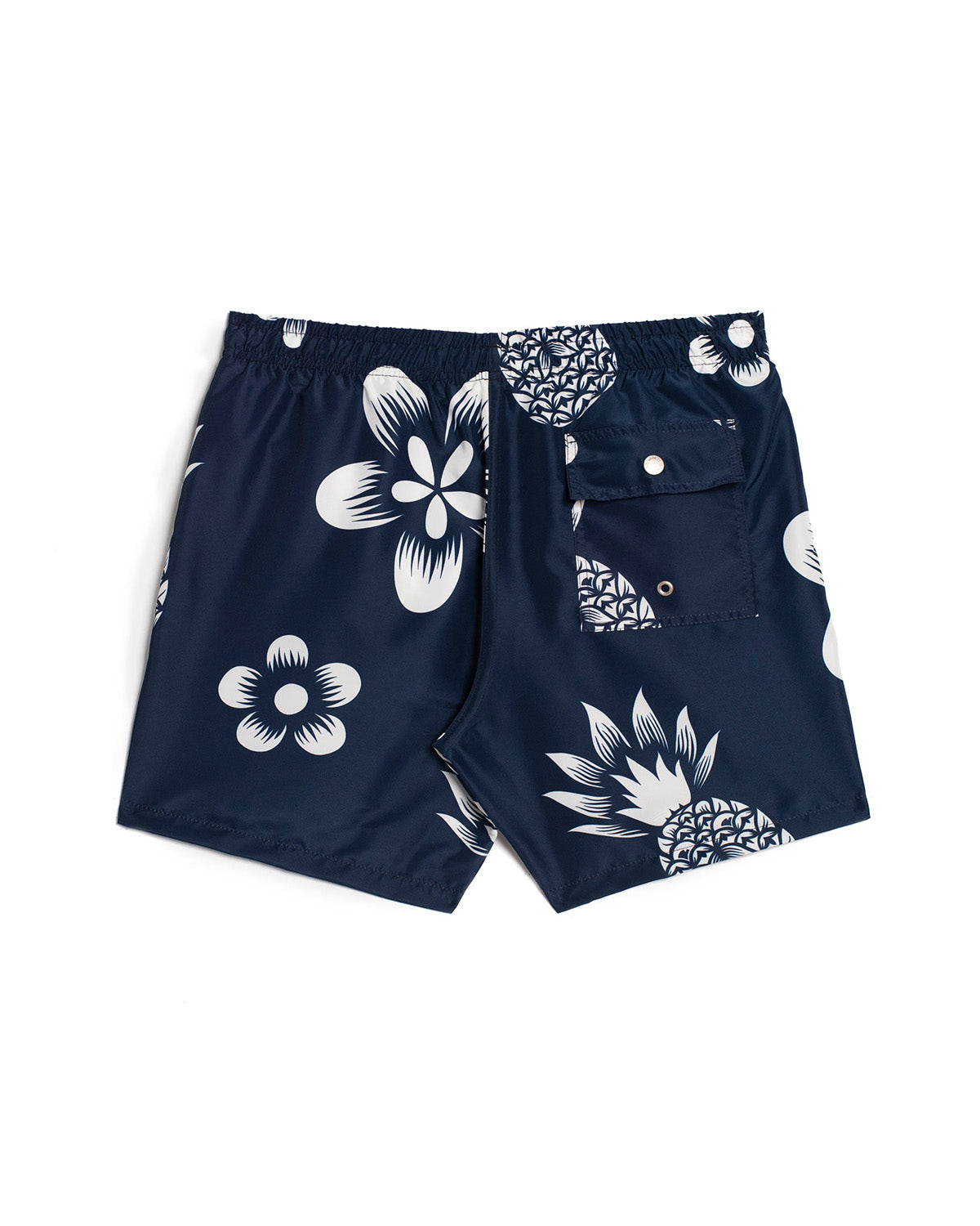 back view of navy Bather swim trunk with white pineapple and floral pattern