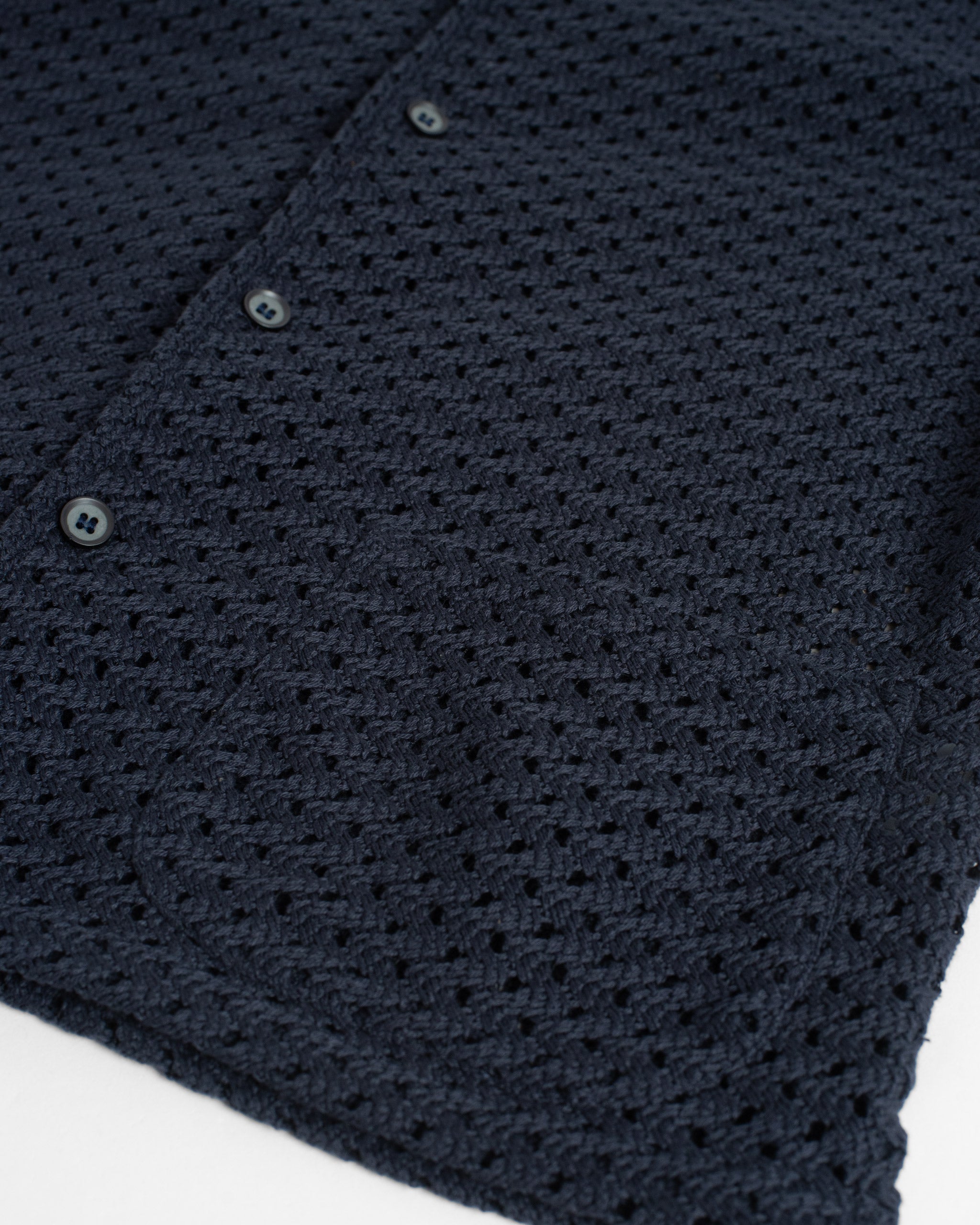 Close-up of black fabric with folds on a white background