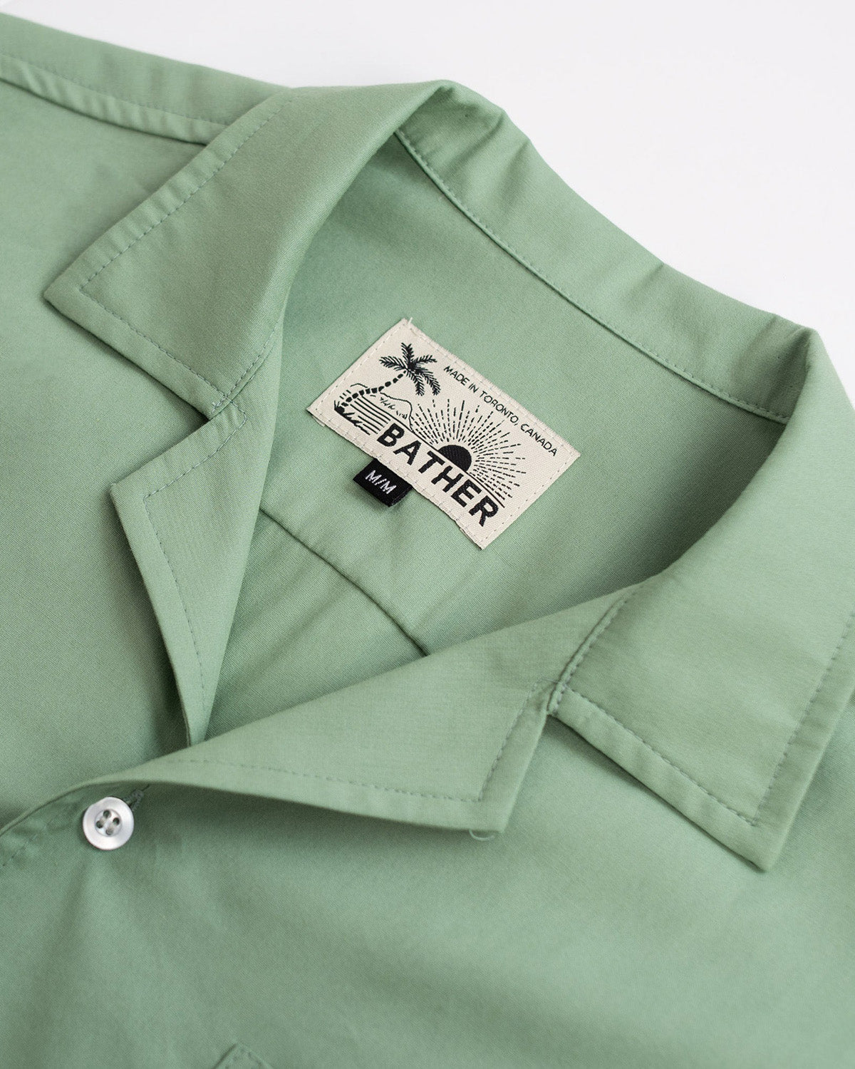 sage green Bather camp shirt close up