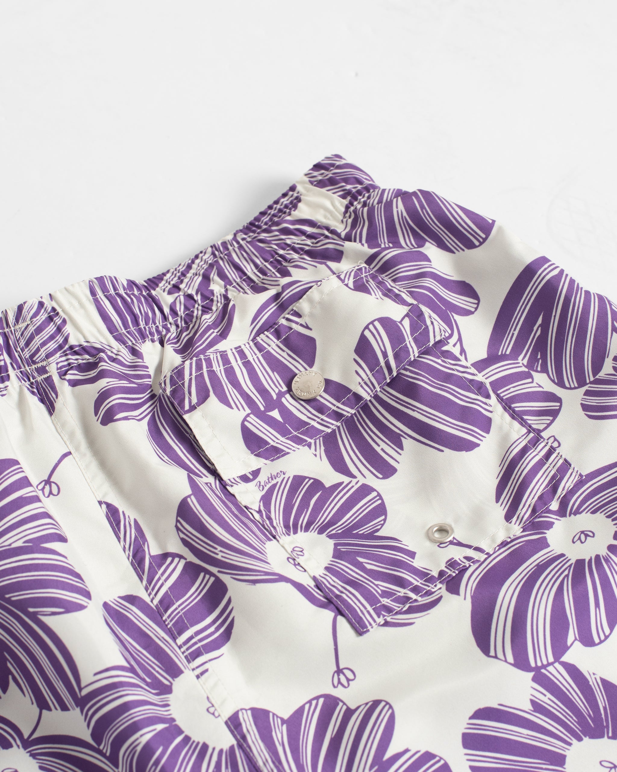 Purple floral patterned short on a white background