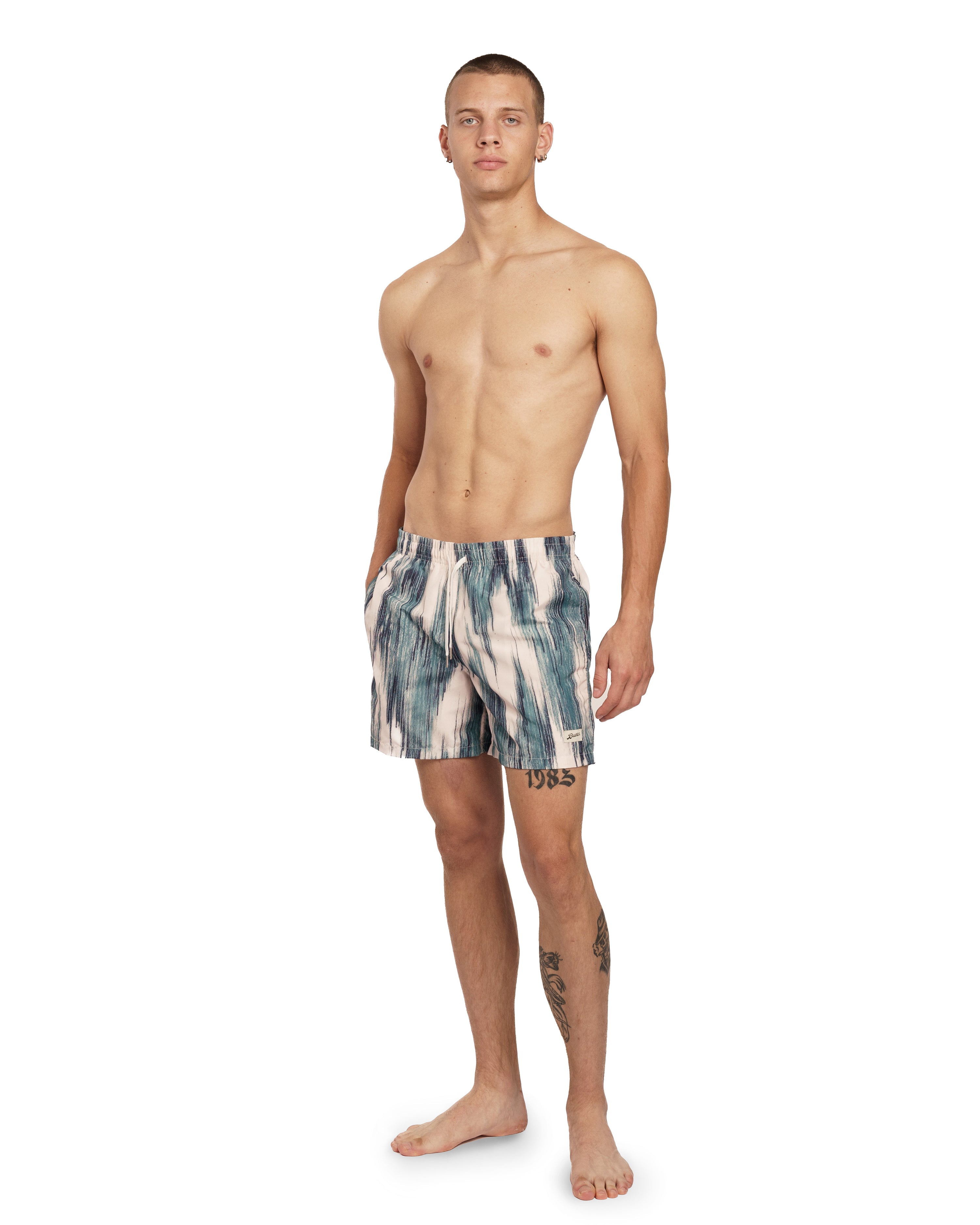 model wearing teal and cream Bather swim trunk with color contrasting pattern