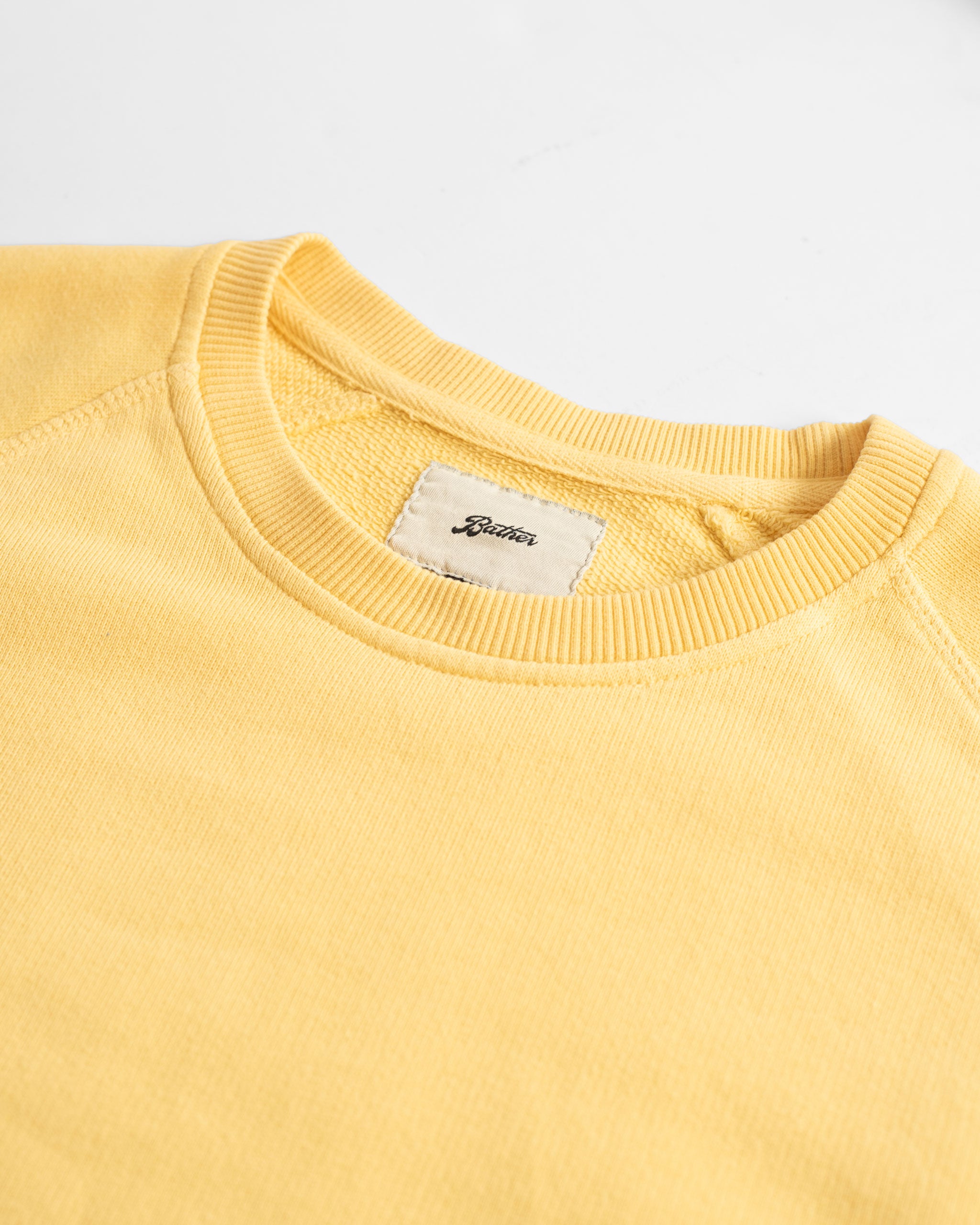 Collar close up of Canary Yellow French Terry Cotton Raglan Sleeve Crewneck Sweatshirt