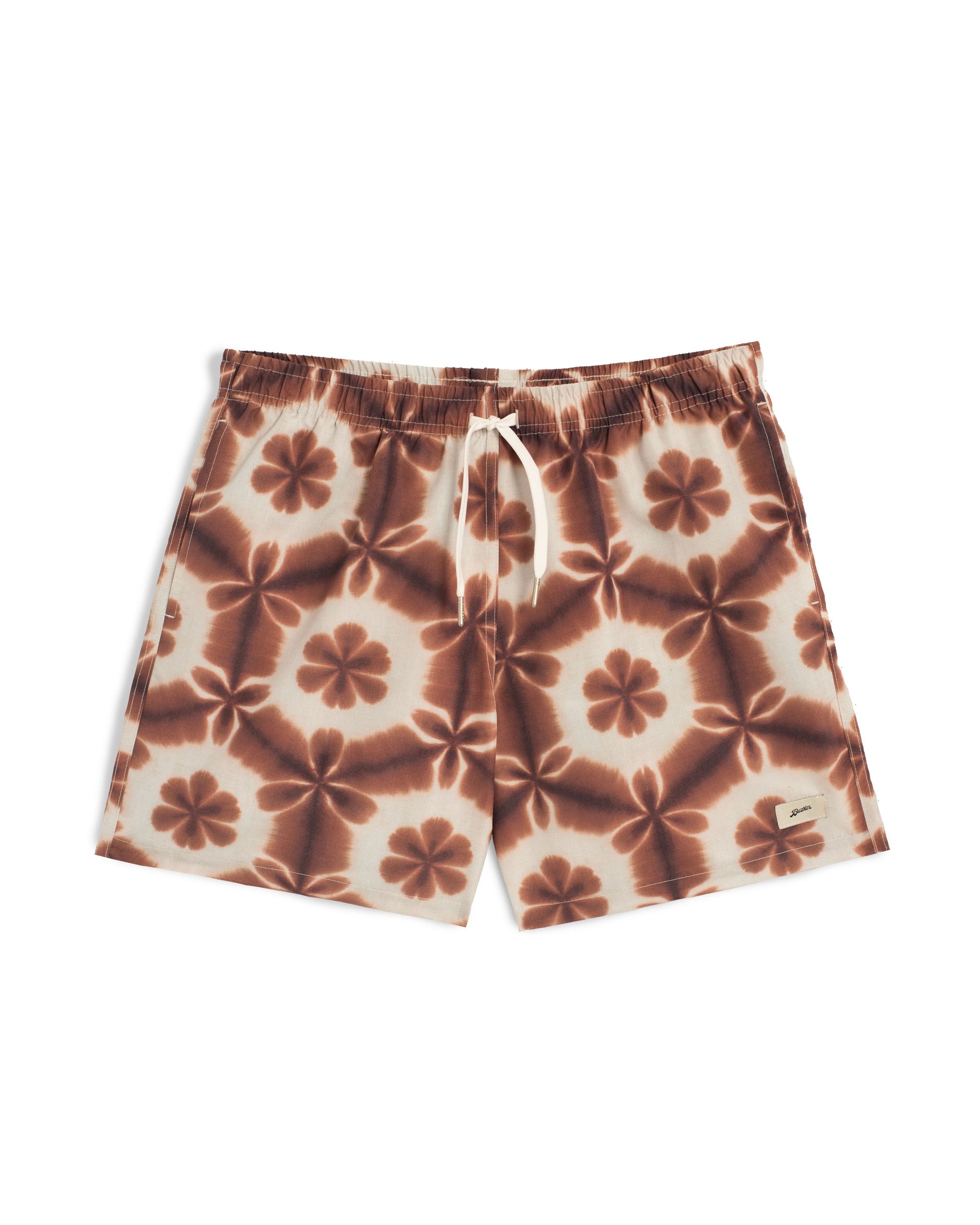 Brown swim trunk with a shibori-inspired print that looks like a kaleidoscope pattern