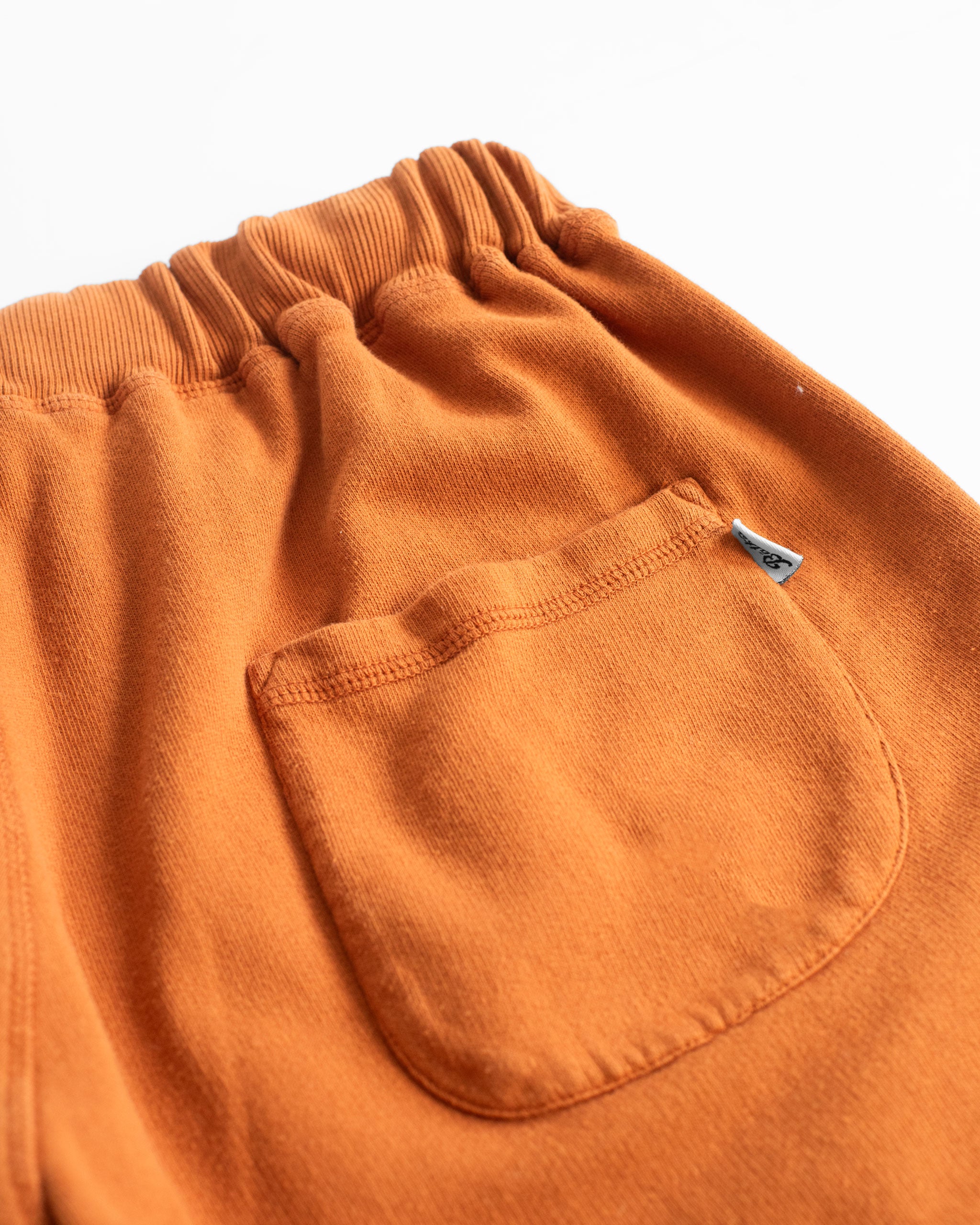 back pocket shot of Orange french terry sweat shorts